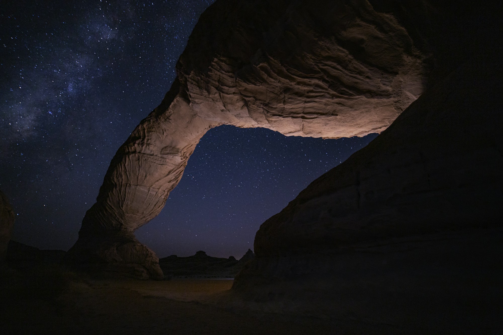 Nabataean tombs of Hegra under a starry sky in AlUla, Saudi Arabia