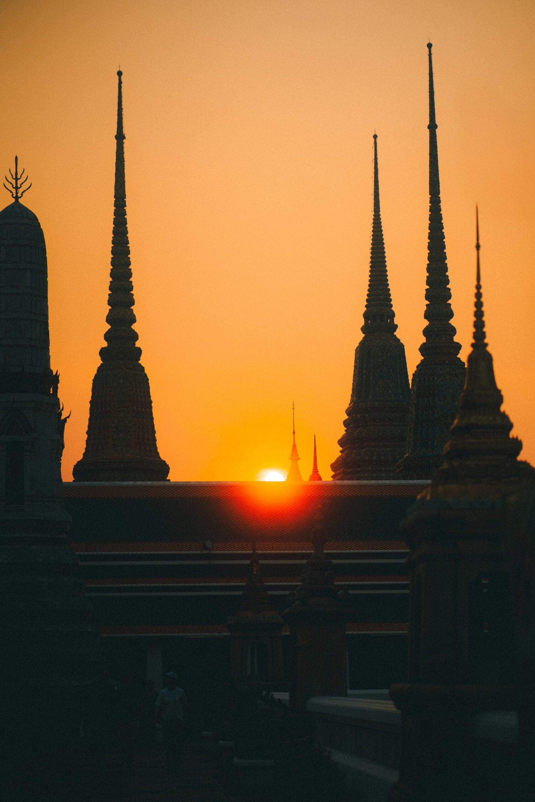 Silhouettes of Bangkok's Buddhist temples at sunset