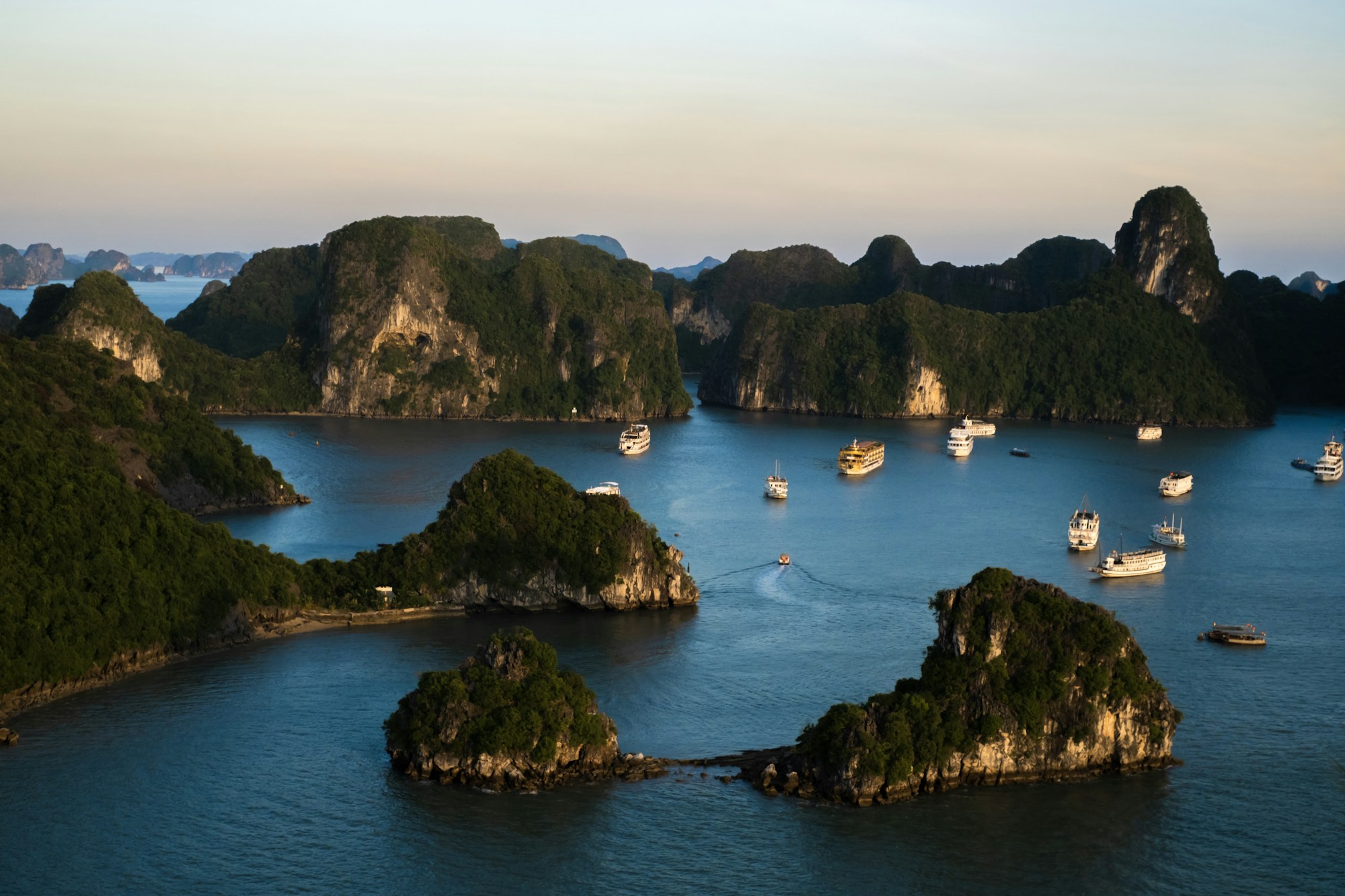 Traditional boats in Ha Long Bay, Vietnam at sunset