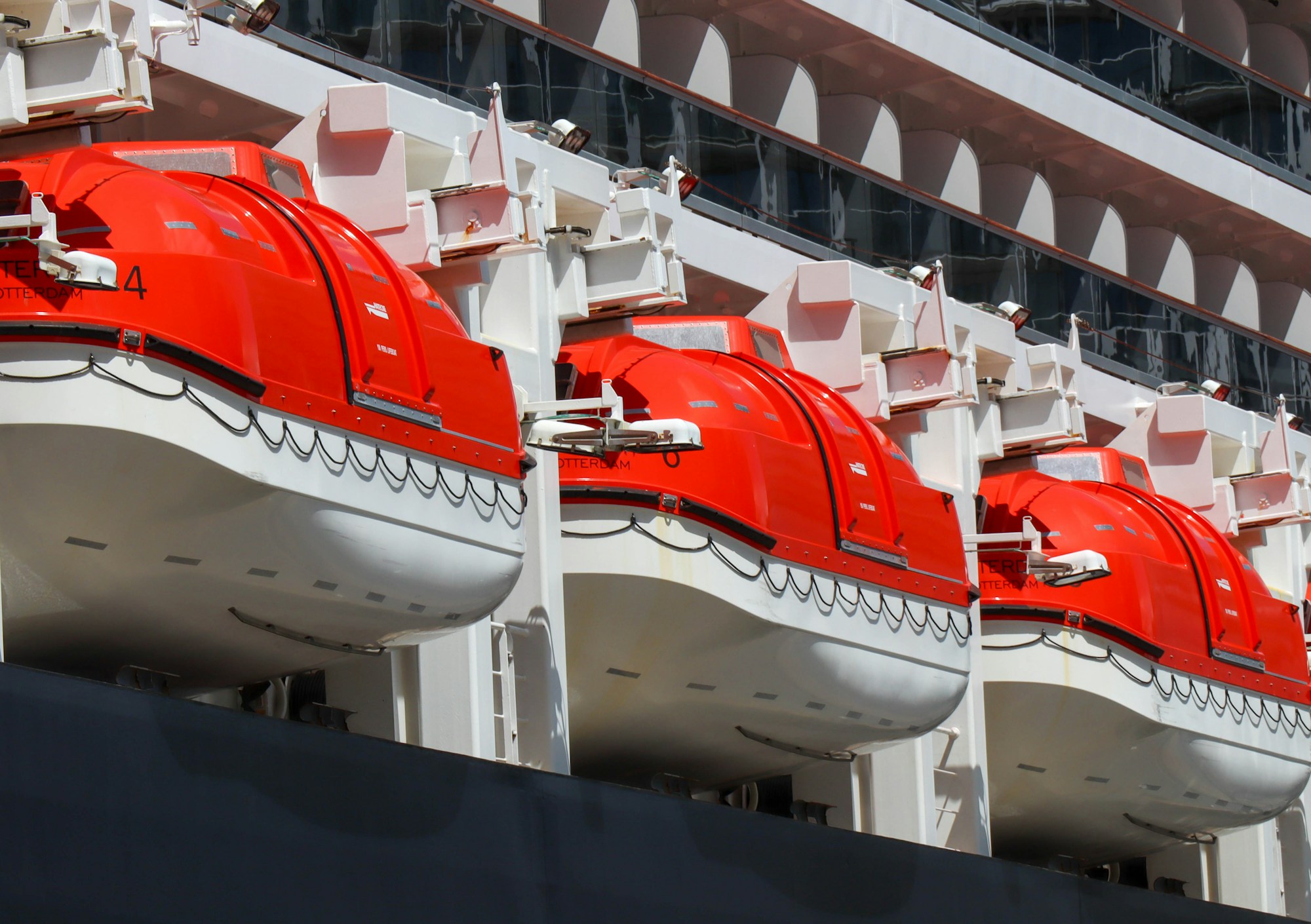 Cruise ship docked in a port with a city view