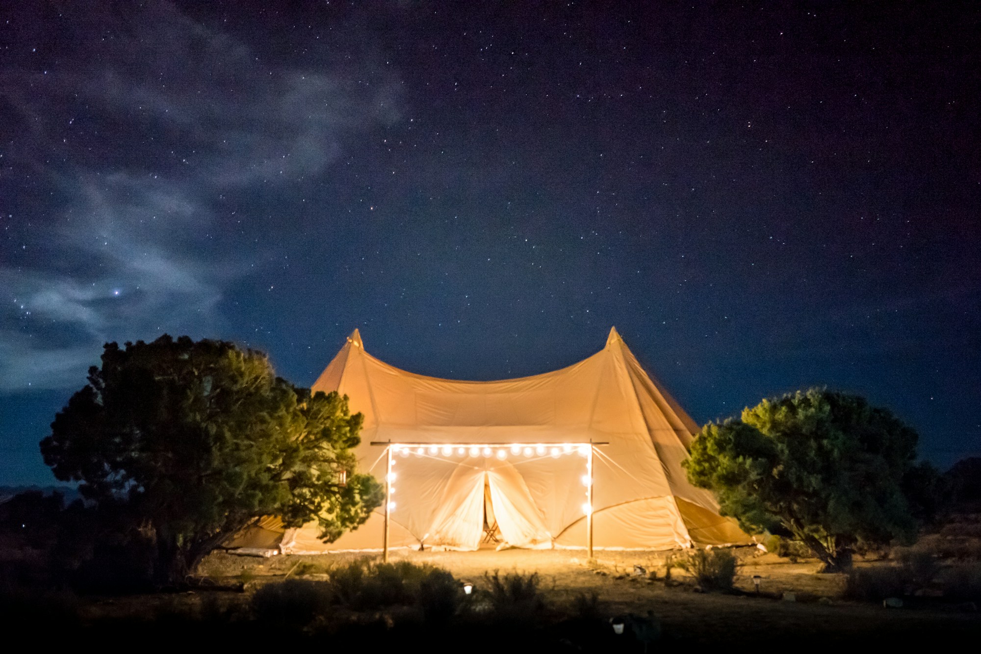 Glamping tent beneath a starry night sky, unusual accommodation in the heart of nature