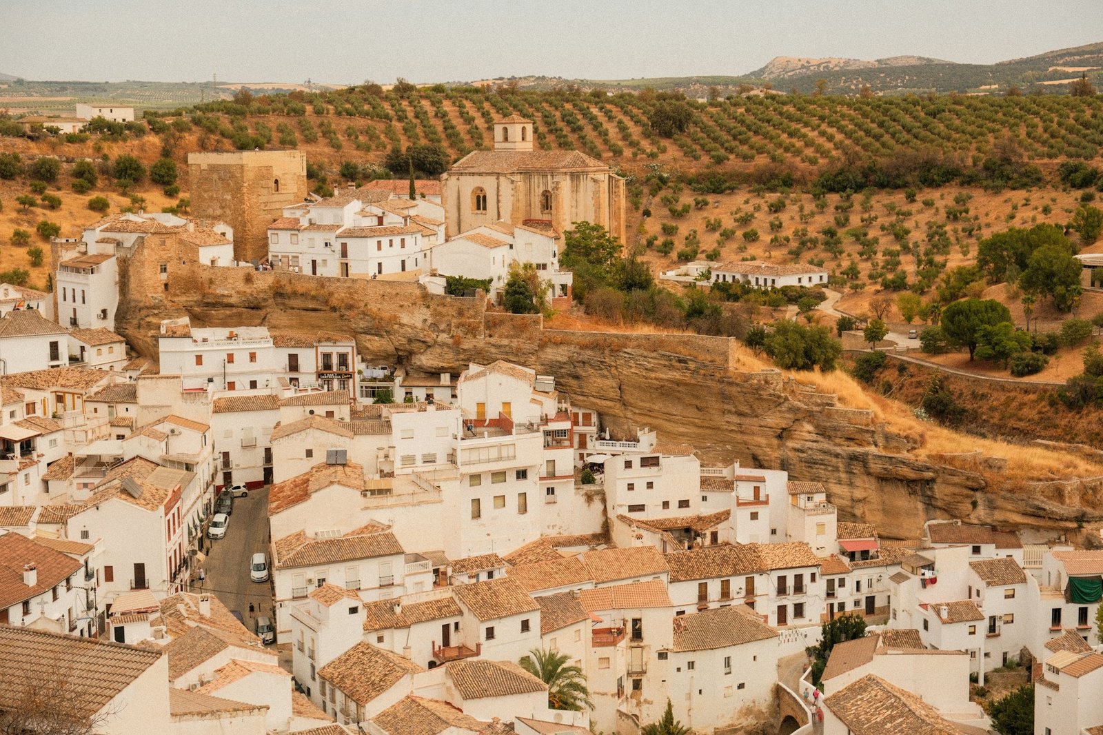 Picturesque alley in an Andalusian village with white walls and colorful flowers