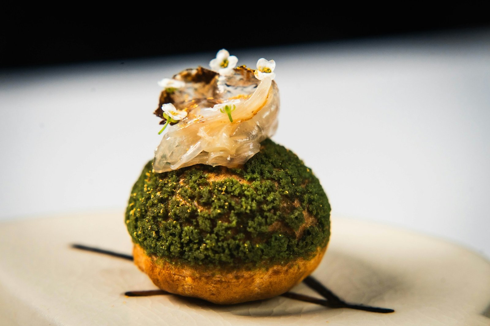 Refined gourmet dish with artistic plating on a dark background