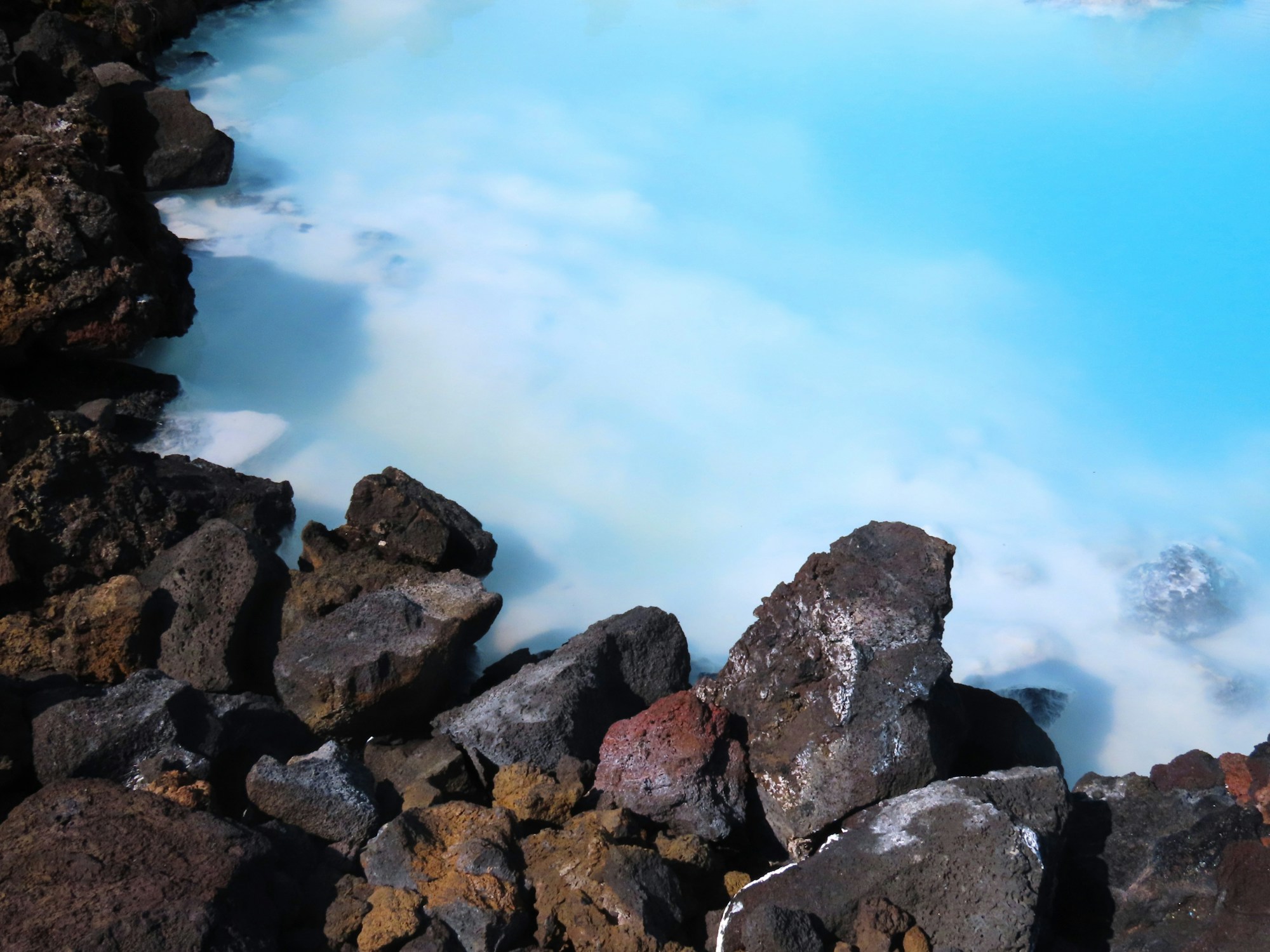 Blue Lagoon in Iceland, milky blue geothermal water amid a volcanic landscape