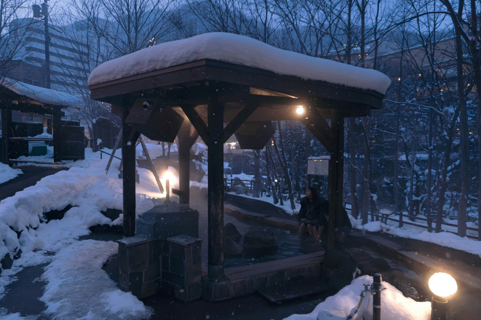 Traditional outdoor onsen in the snow in Japan, a thermal bath surrounded by nature