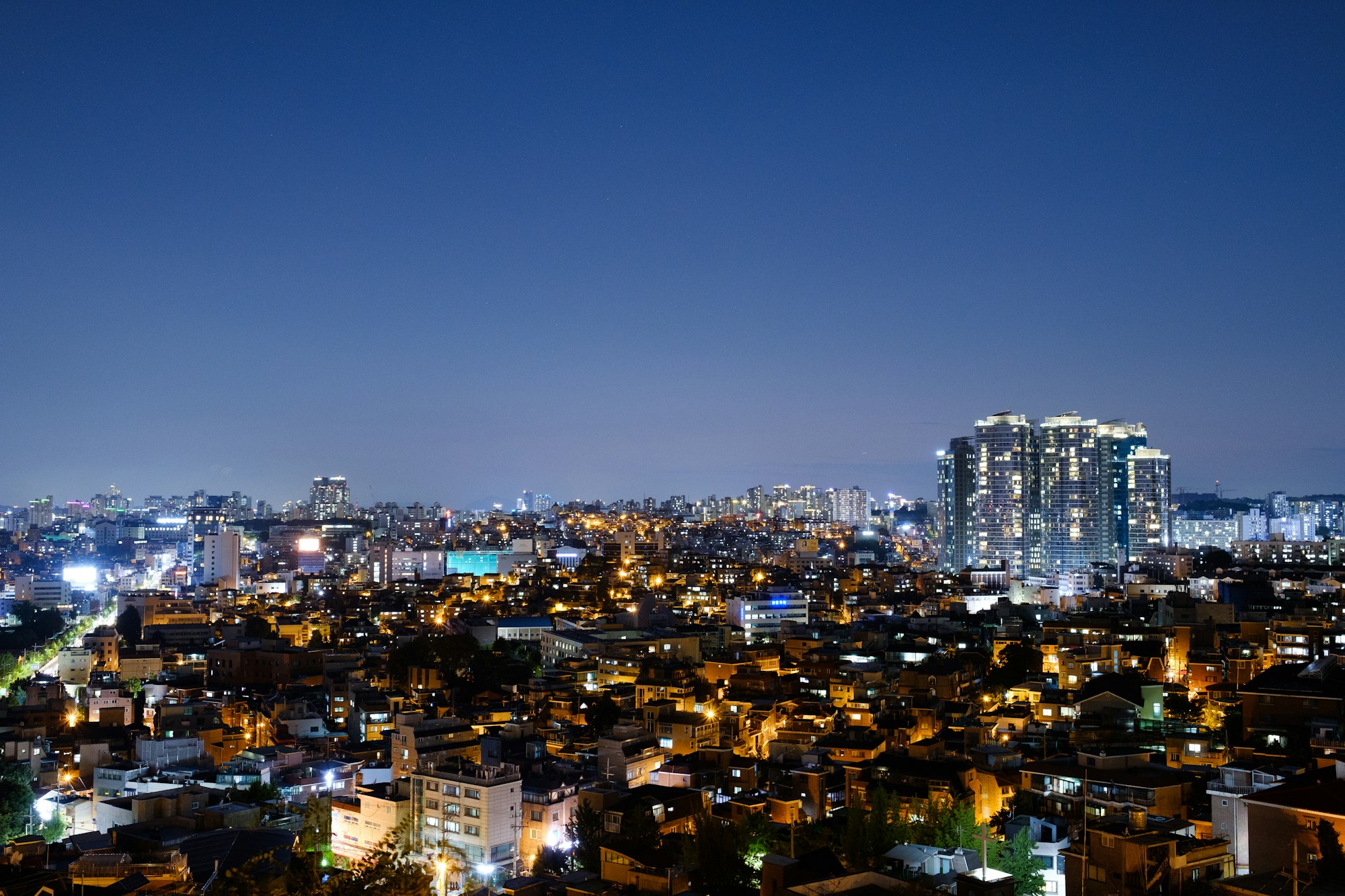 Vibrant Itaewon neighborhood in Seoul at night with neon signs, filming location of Itaewon Class