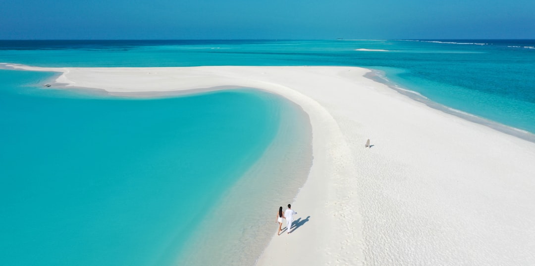 Pristine white sandy beach on a Maldivian island with turquoise water