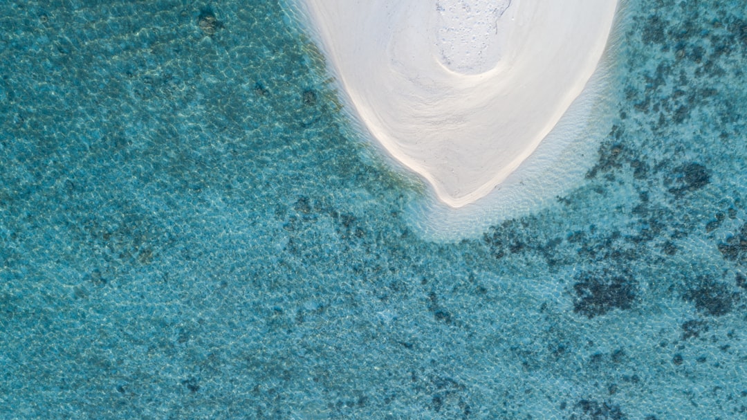 Aerial view of a Maldivian island surrounded by a turquoise lagoon