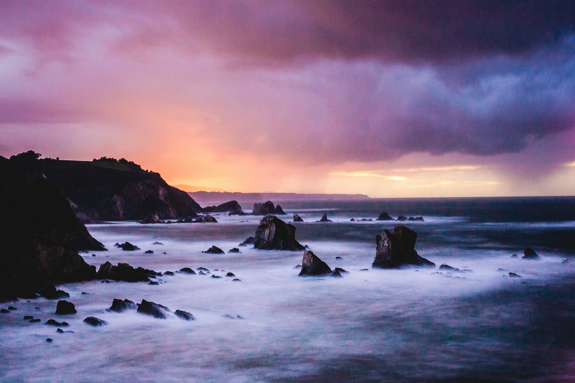 Playa de Gulpiyuri, the world's smallest beach landlocked in the fields near Llanes in Asturias, Spain