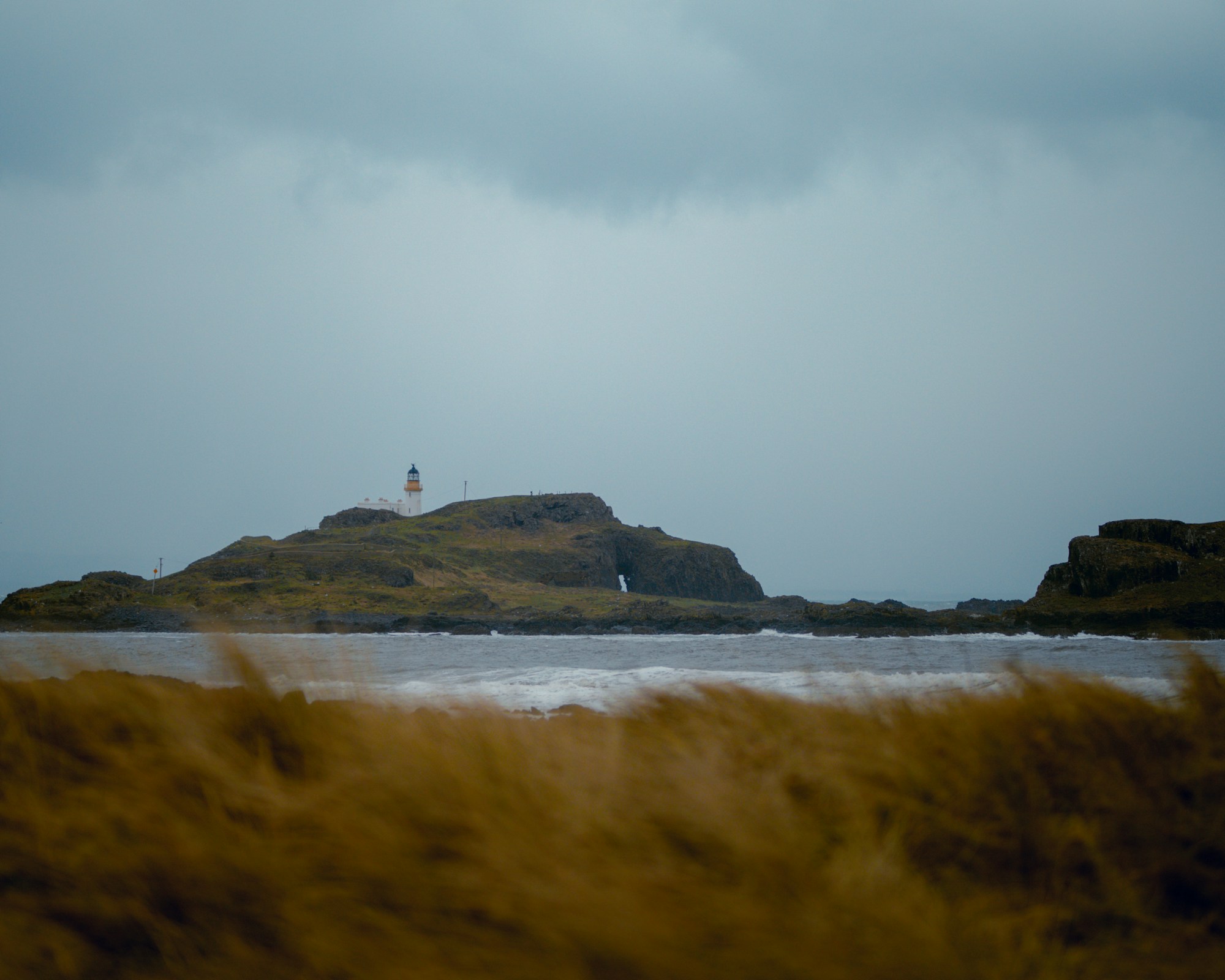Seacliff Beach in Scotland with the medieval Tantallon Castle on the cliff and Bass Rock in the distance