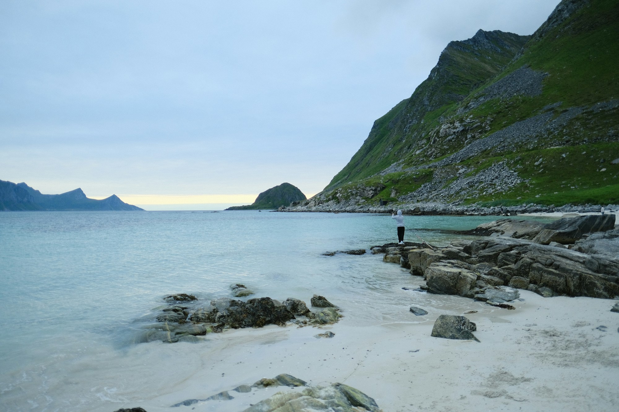 Haukland Beach in the Lofoten Islands, Norway, white sand and turquoise waters framed by Arctic mountains under the midnight sun