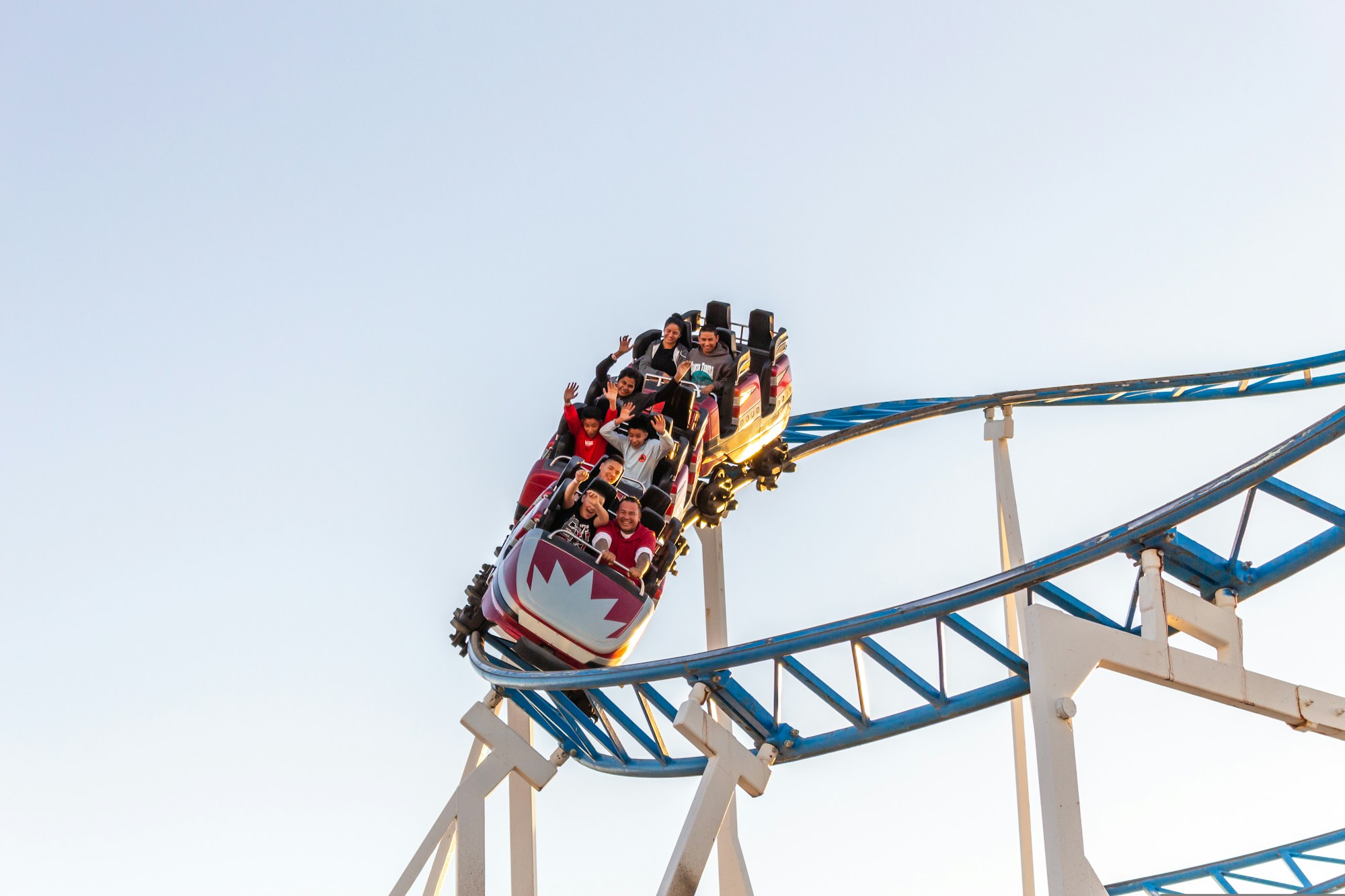 Roller coaster in action at a sunny theme park evoking PortAventura World