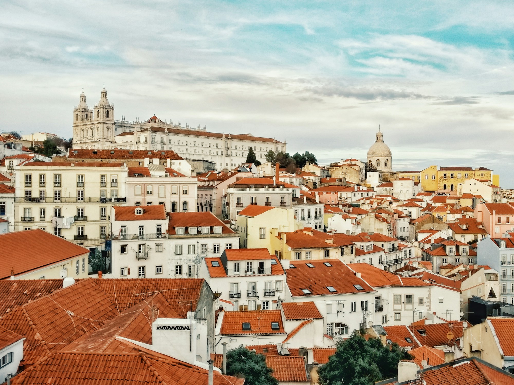 Panoramic view of the Alfama district in Lisbon, Portugal, a top coliving destination for remote workers