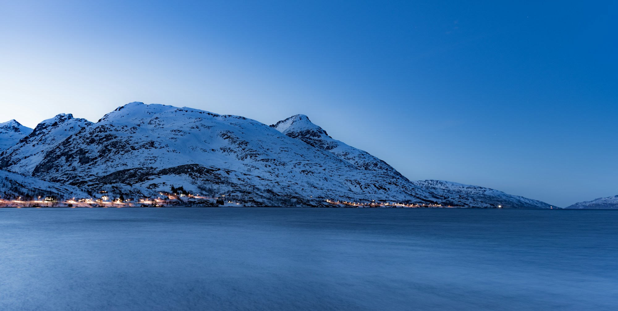 Landscape of Tromsø in Norway with mountains and fjords under the midnight sun