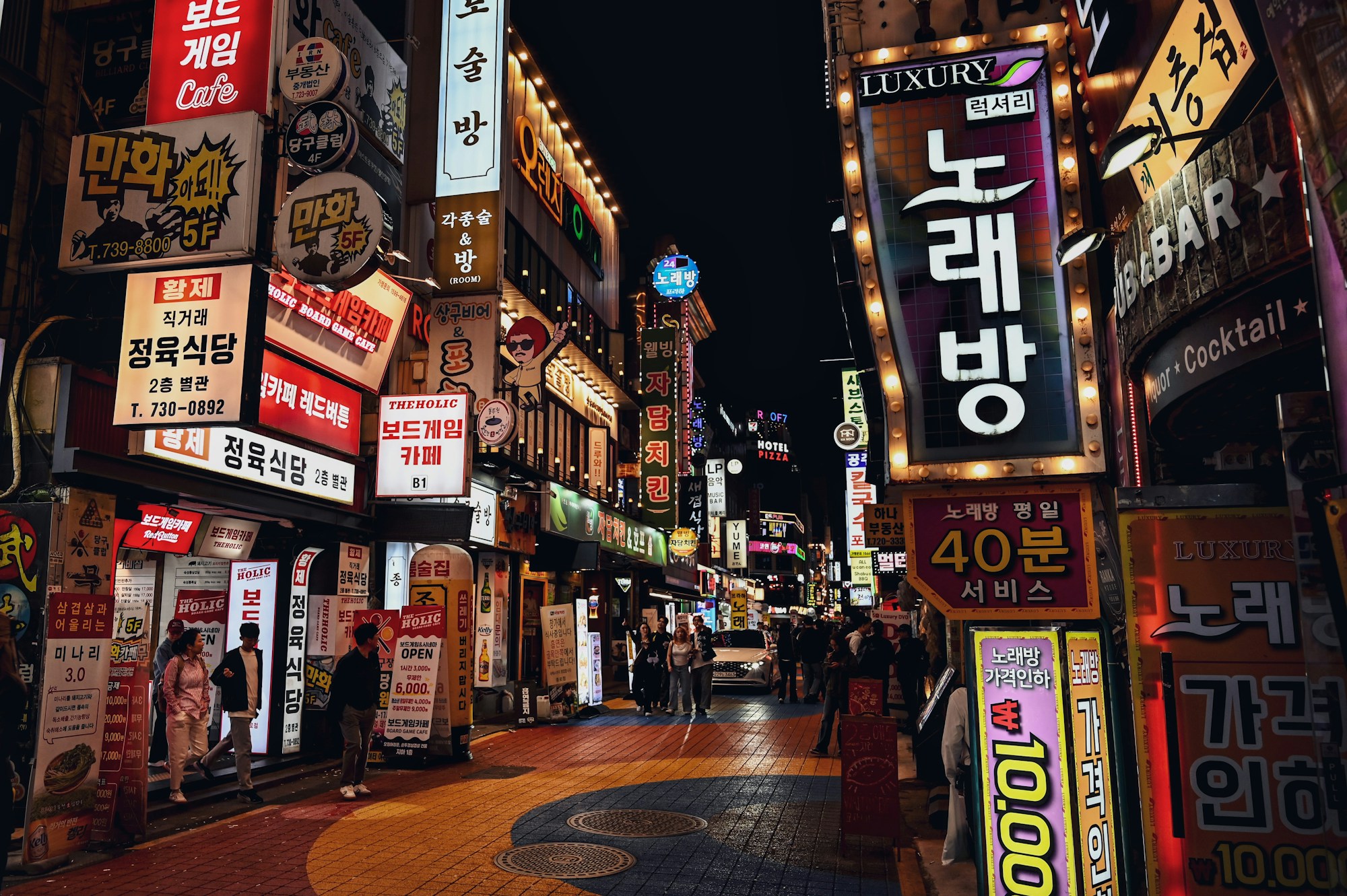 Seoul by night, animated street in the Jongno district with neon signs and evening crowds