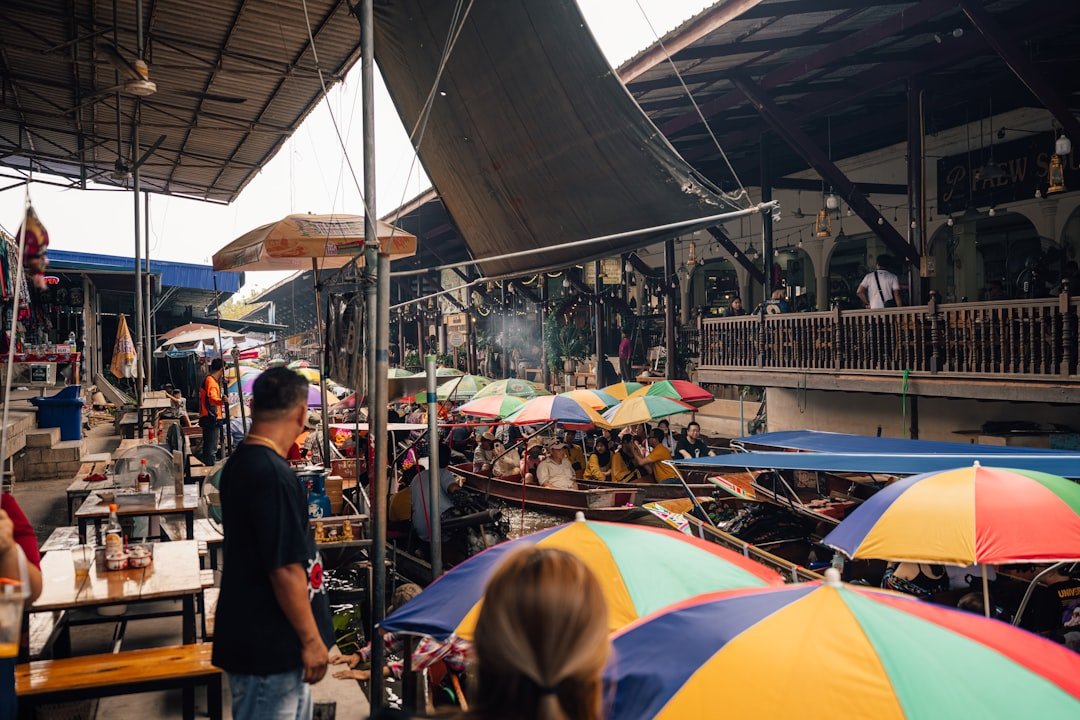 Colorful floating market with fruits and street food dishes in Thailand