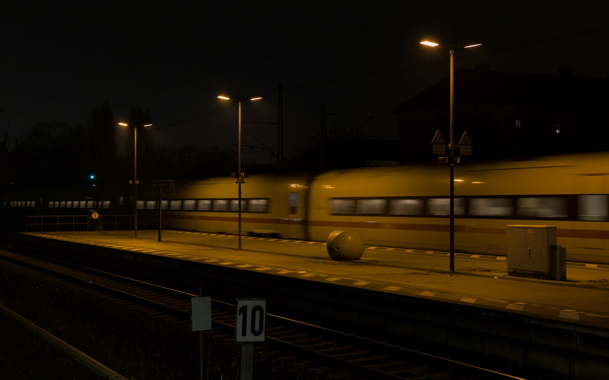 Train traversant une gare illuminée de nuit