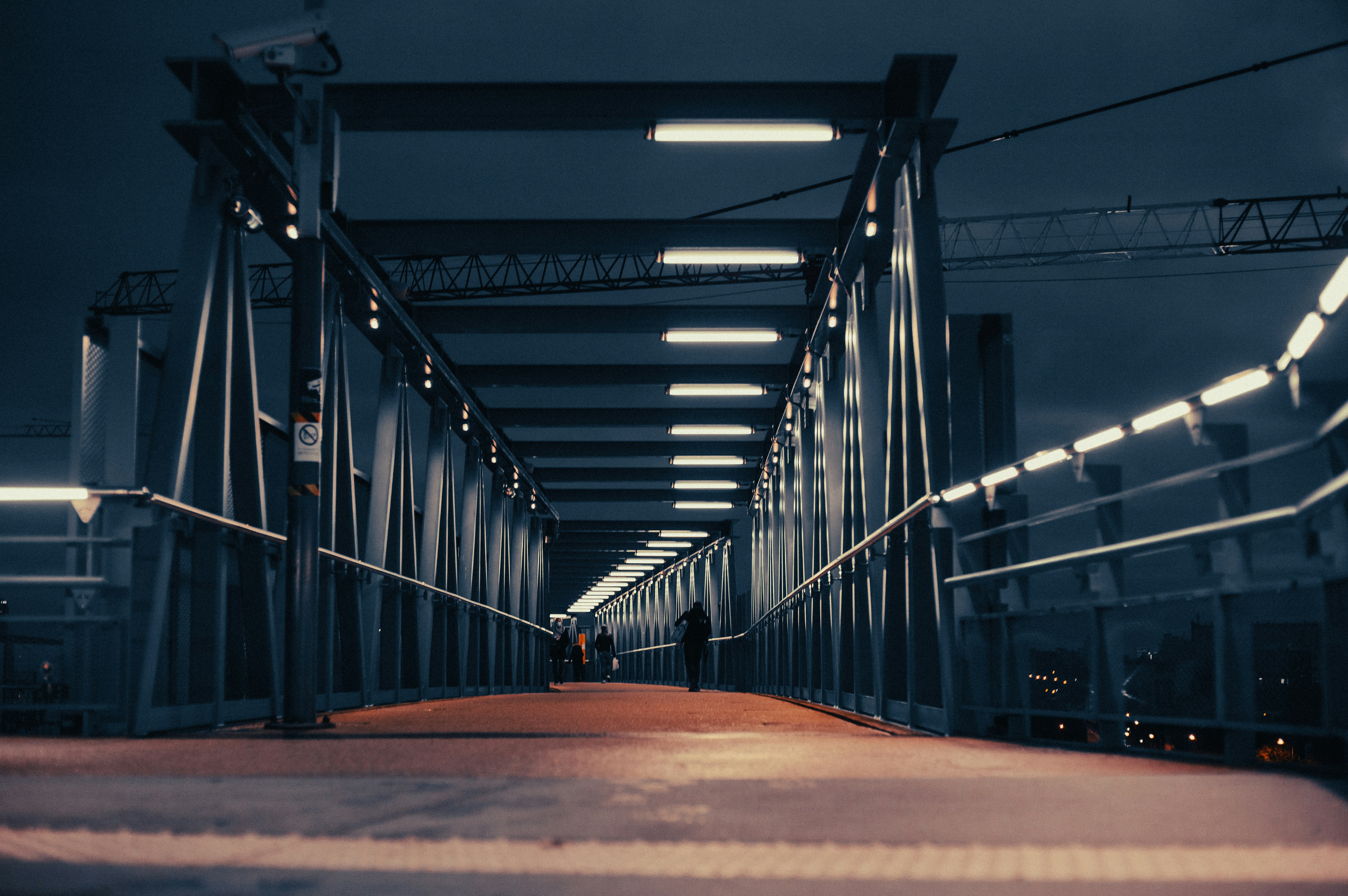 Illuminated bridge at night in Paris with reflections on the Seine