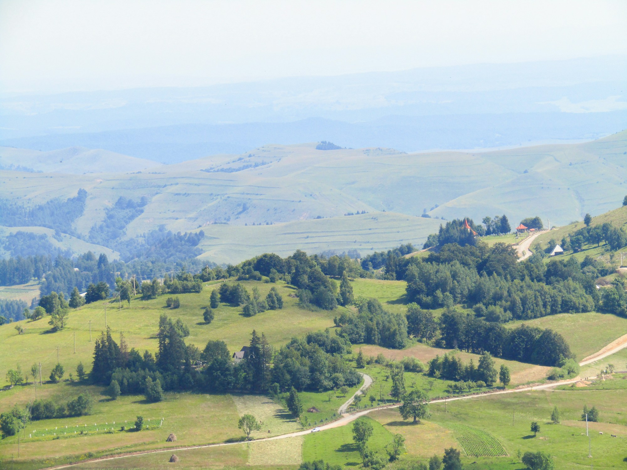 Traditional Transylvanian village in Romania with green hills