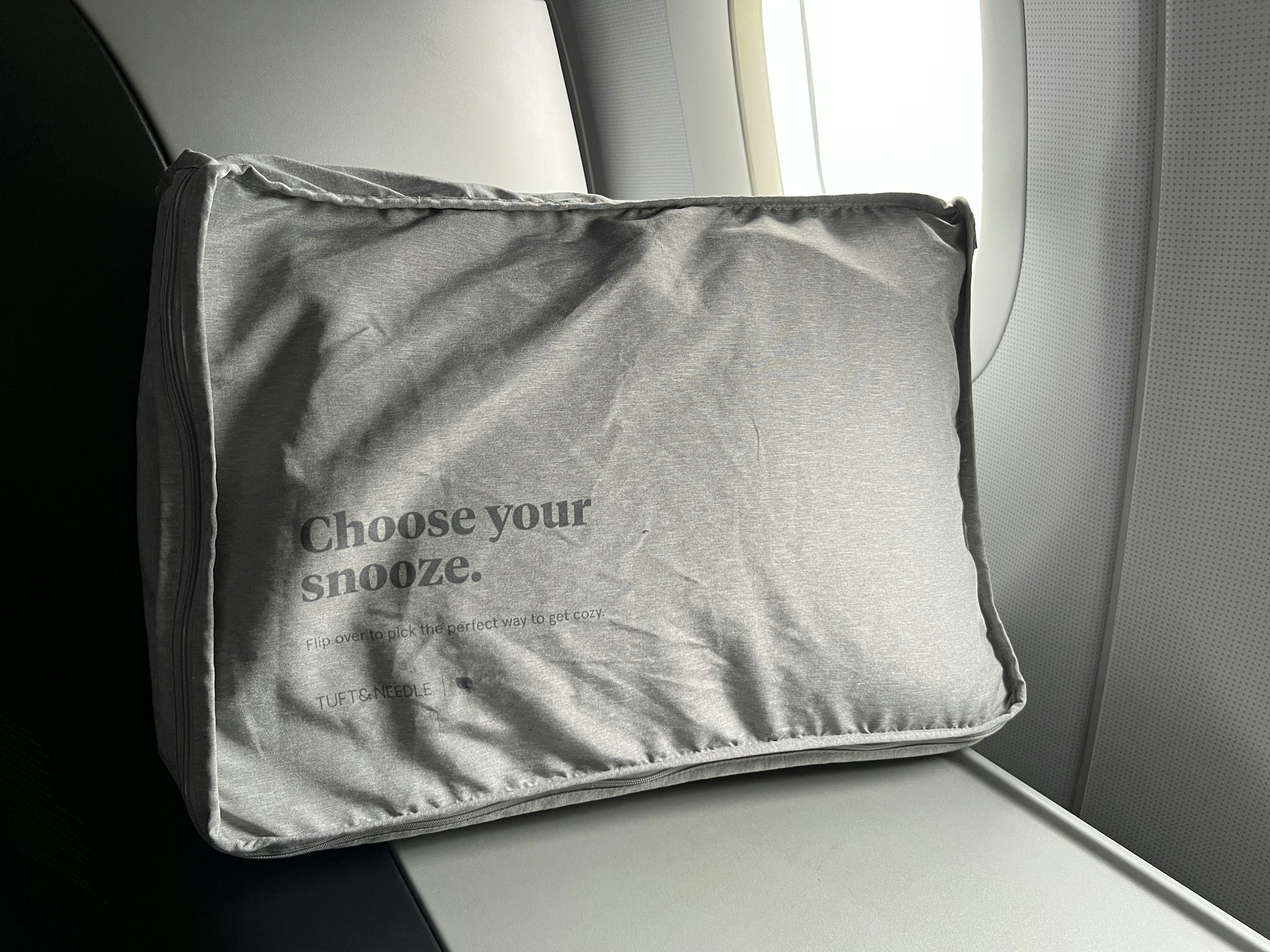 Travel accessories for a long-haul flight laid out flat