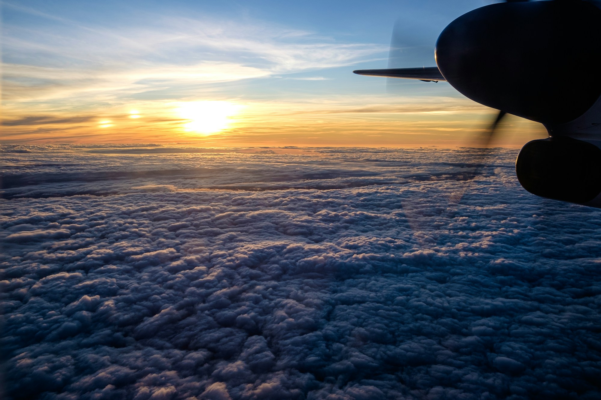 Traveler watching the sunrise after a long-haul flight