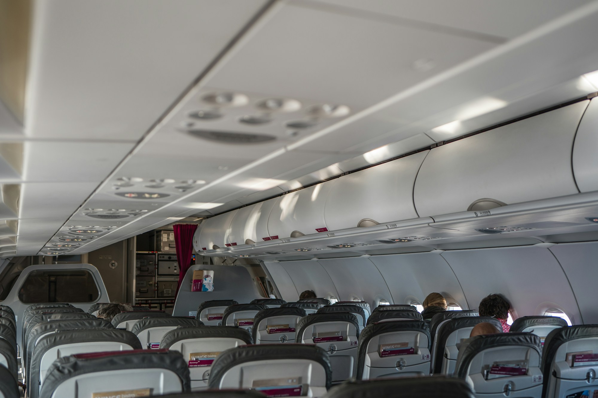 Rows of seats in an economy class airplane cabin