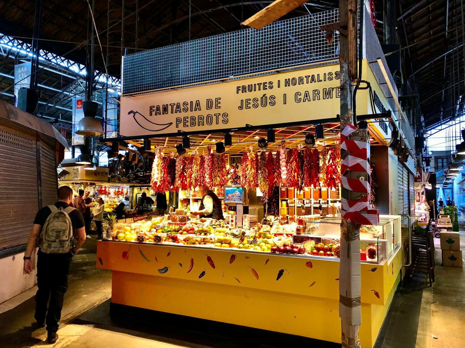 Colorful stall at La Boqueria market in Barcelona with fresh fruits and vegetables