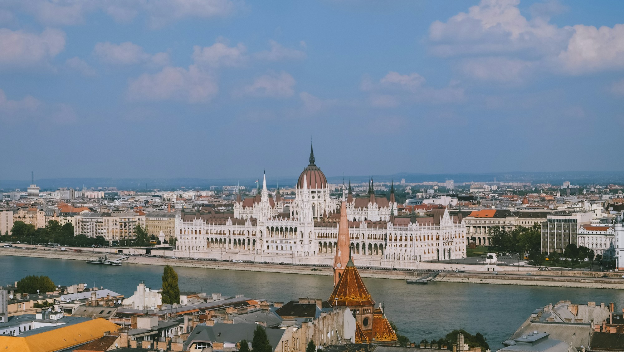 Panoramic view of the illuminated Budapest Parliament along the Danube, a Central European coliving destination