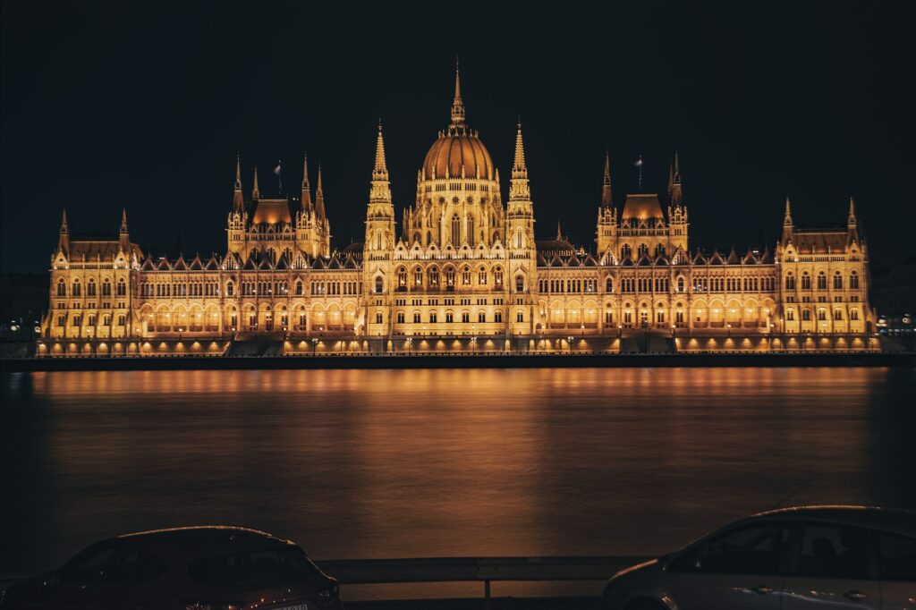Parlement de Budapest illuminé au bord du Danube la nuit