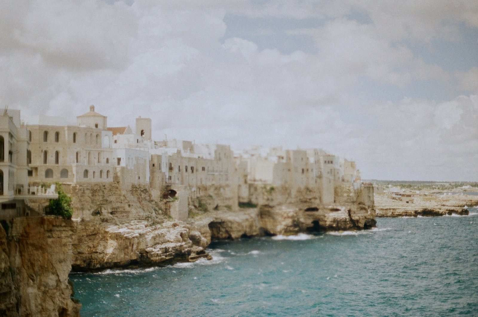 View of the cliffs and whitewashed houses of Polignano a Mare overlooking the Adriatic Sea, Puglia, Italy