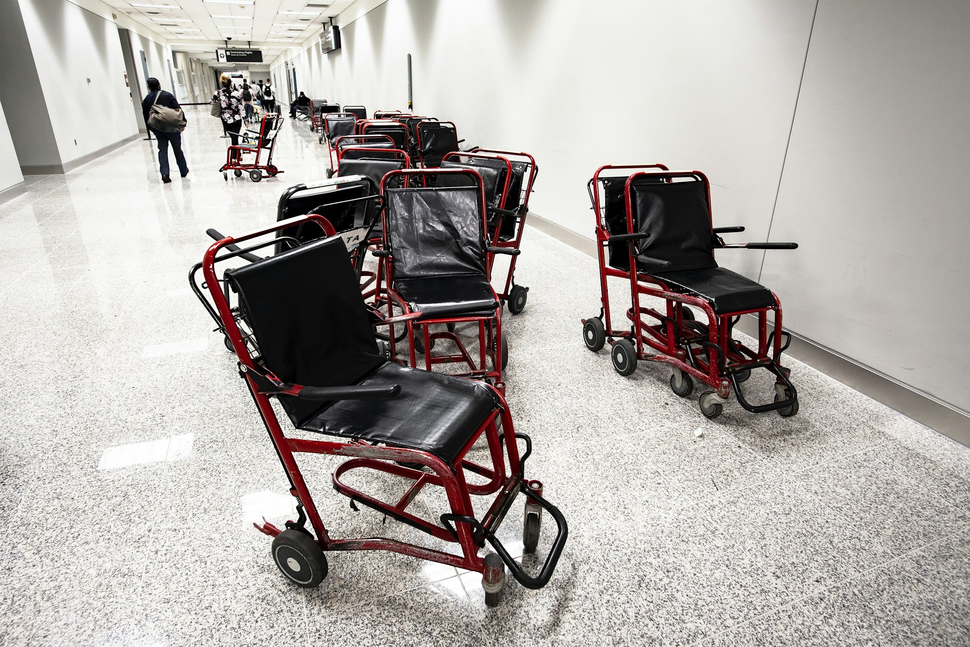 Wheelchair passenger at the airport receiving mobility assistance