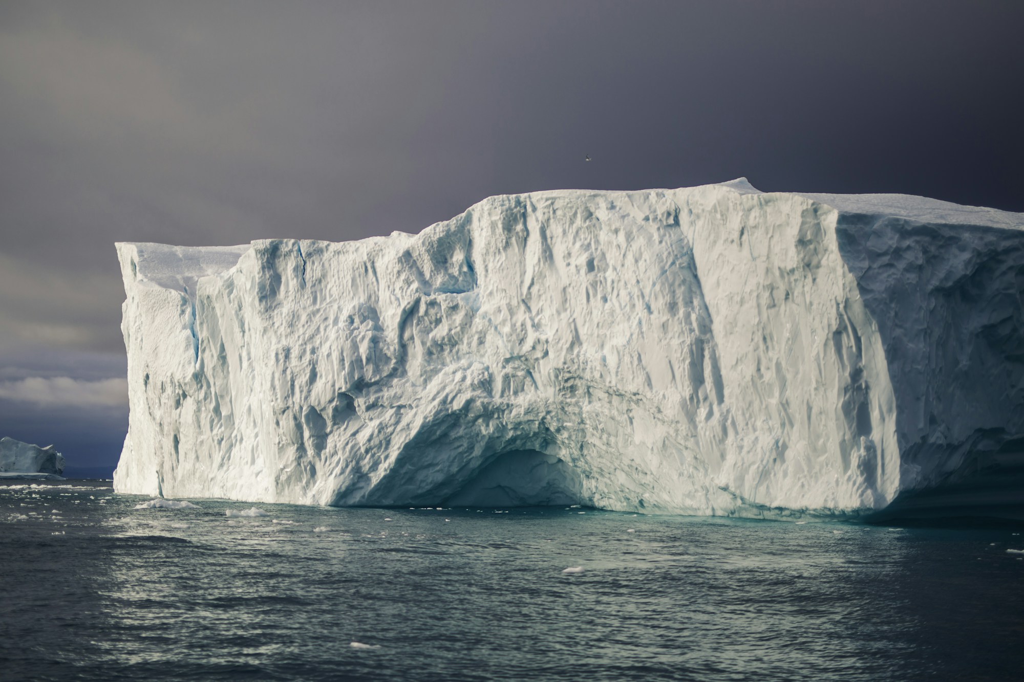 Colossal iceberg in Disko Bay at Ilulissat, Greenland, under a clear Arctic sky