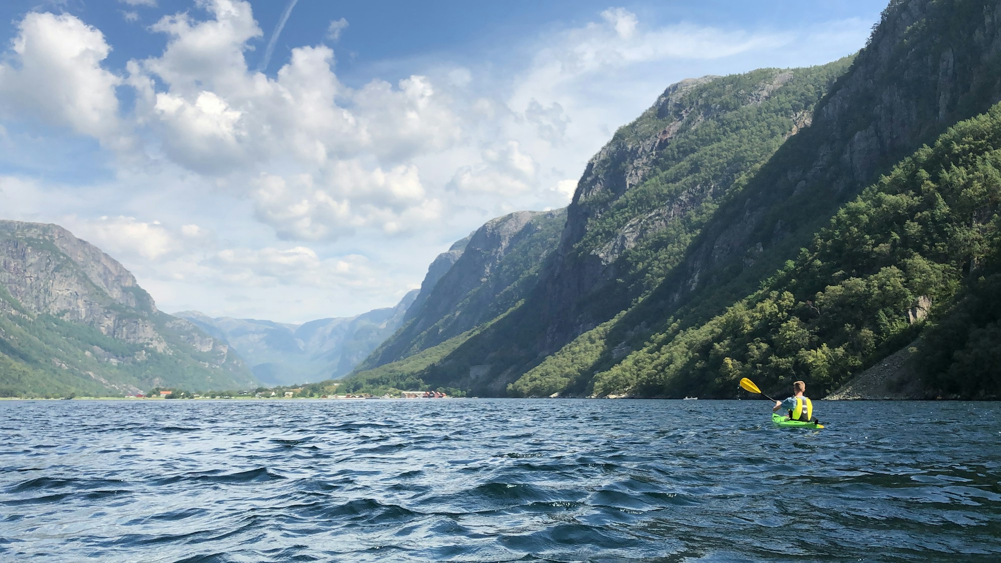 Sea kayaking in the Nærøyfjord at Gudvangen, Norway, surrounded by sheer cliffs