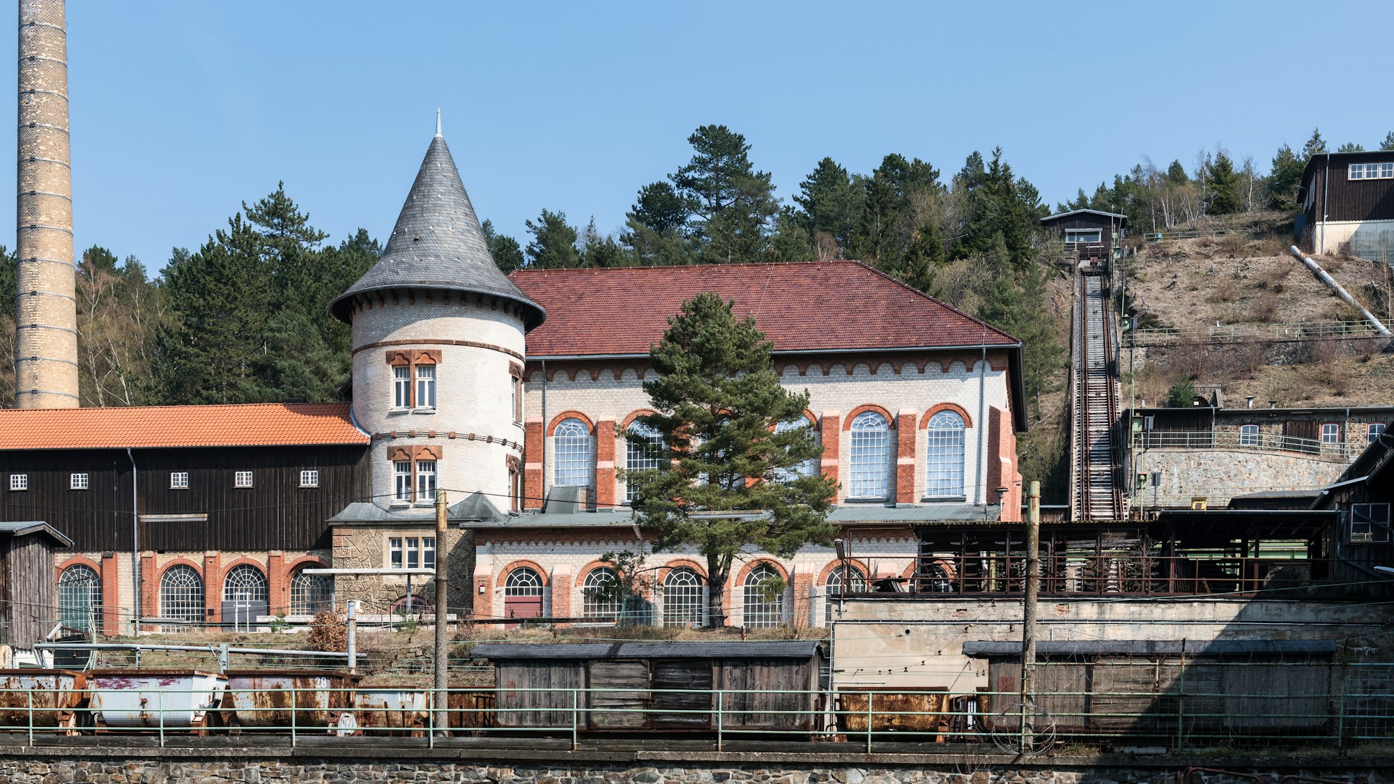 Abandoned industrial buildings with chimney, post-apocalyptic atmosphere