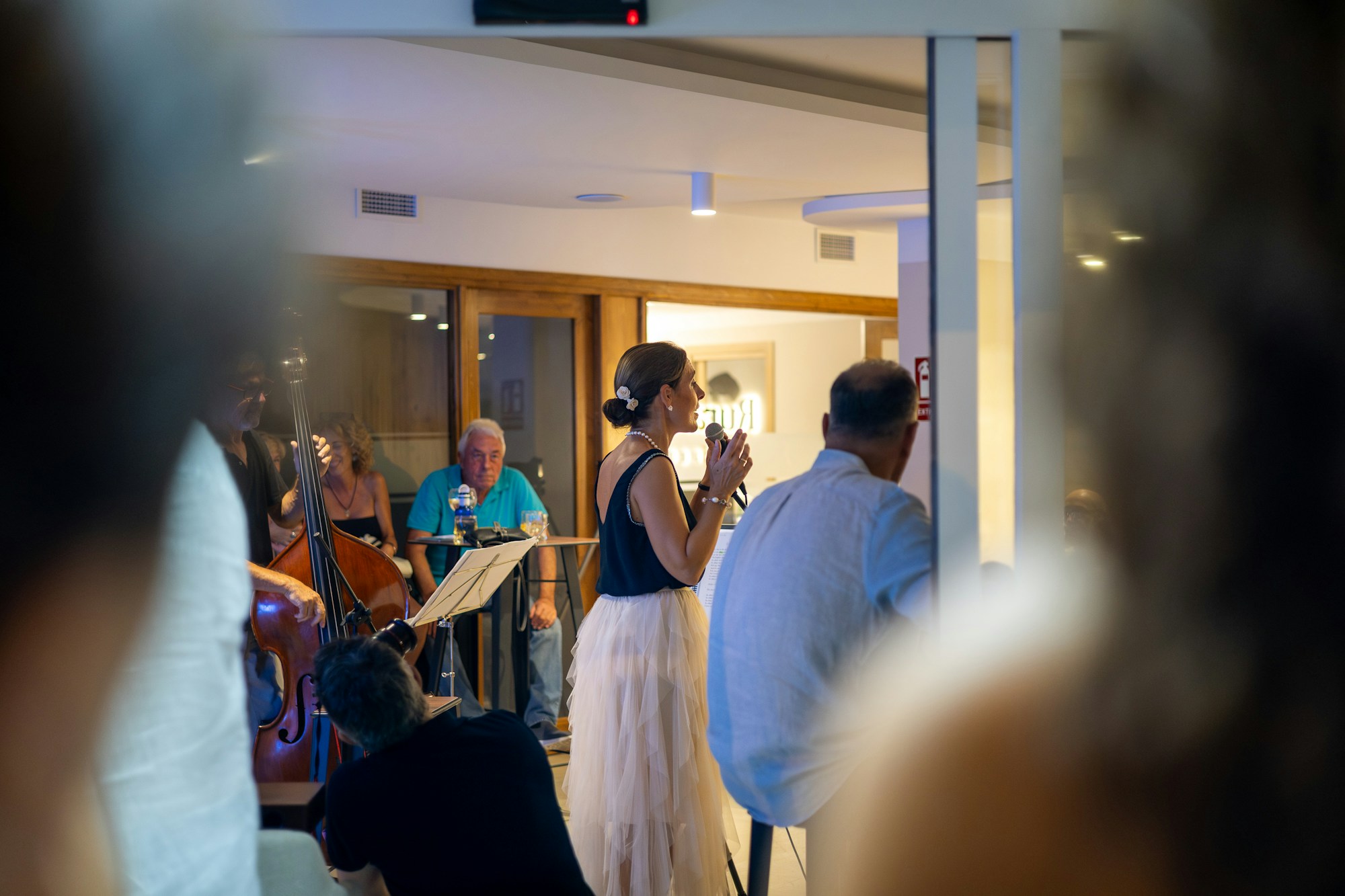 Female singer performing on stage at a jazz concert, warm concert atmosphere