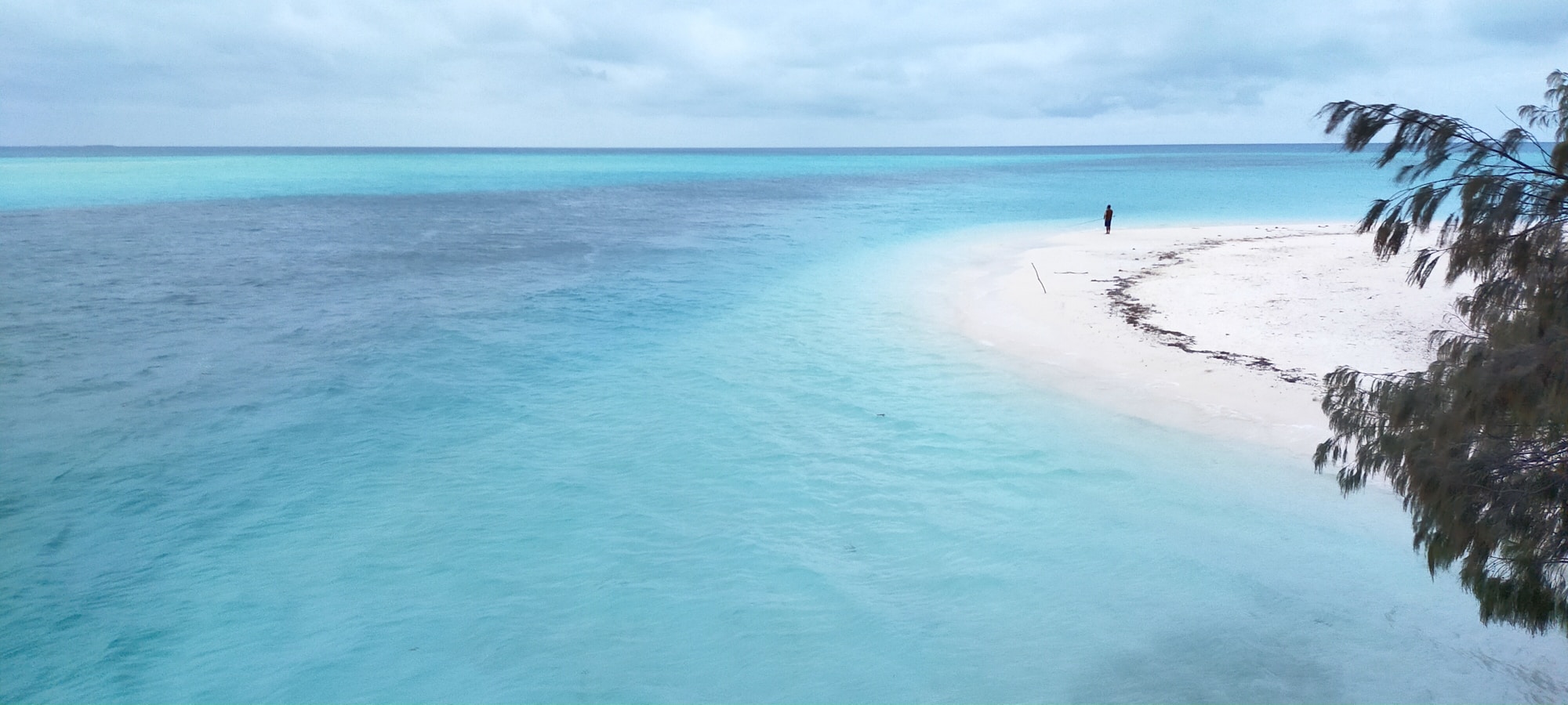 Pristine white sand beach of Ouvéa with its turquoise lagoon, New Caledonia — the island closest to paradise