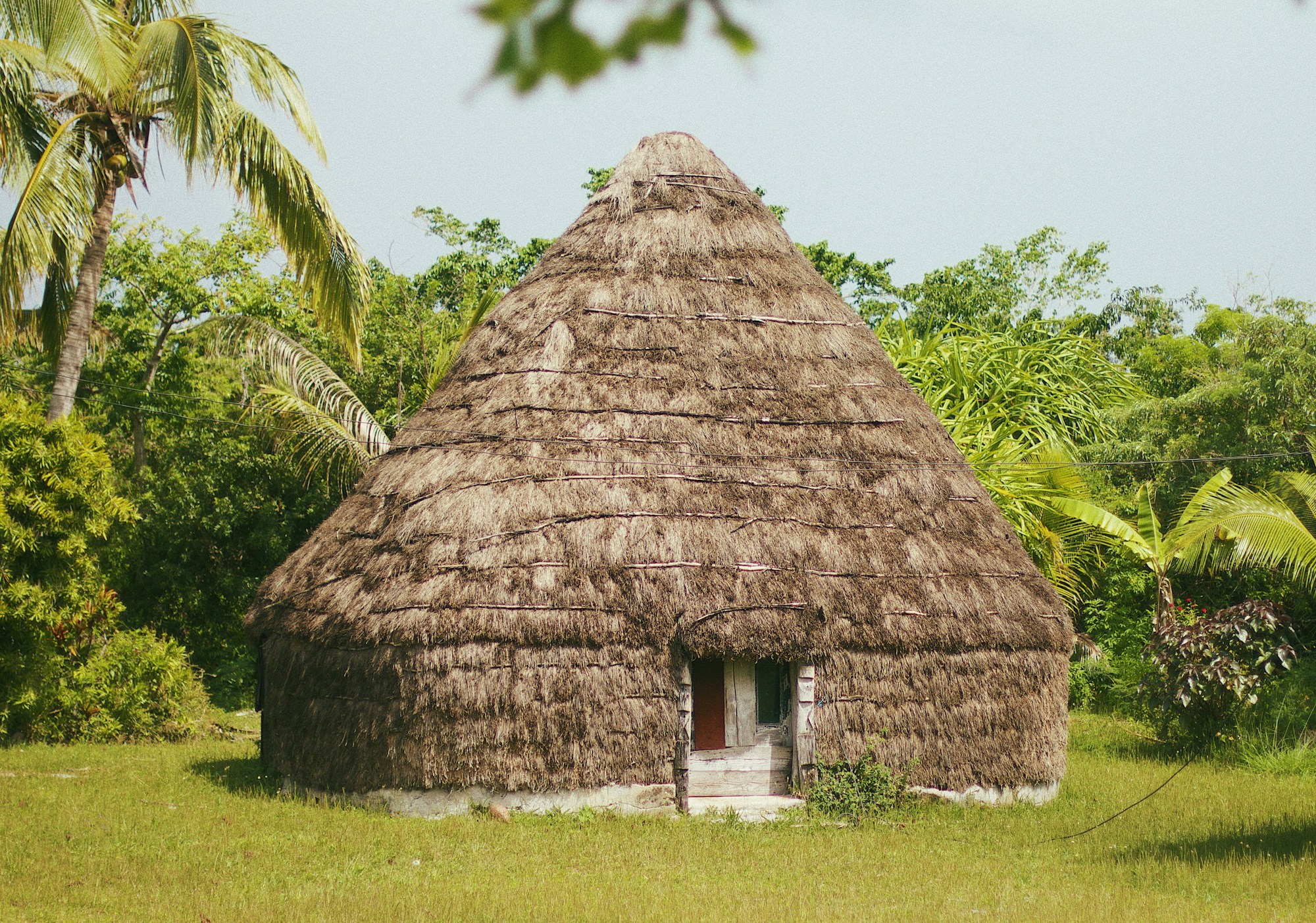 Traditional Kanak hut in Lifou, New Caledonia — ancestral Melanesian architecture on customary land