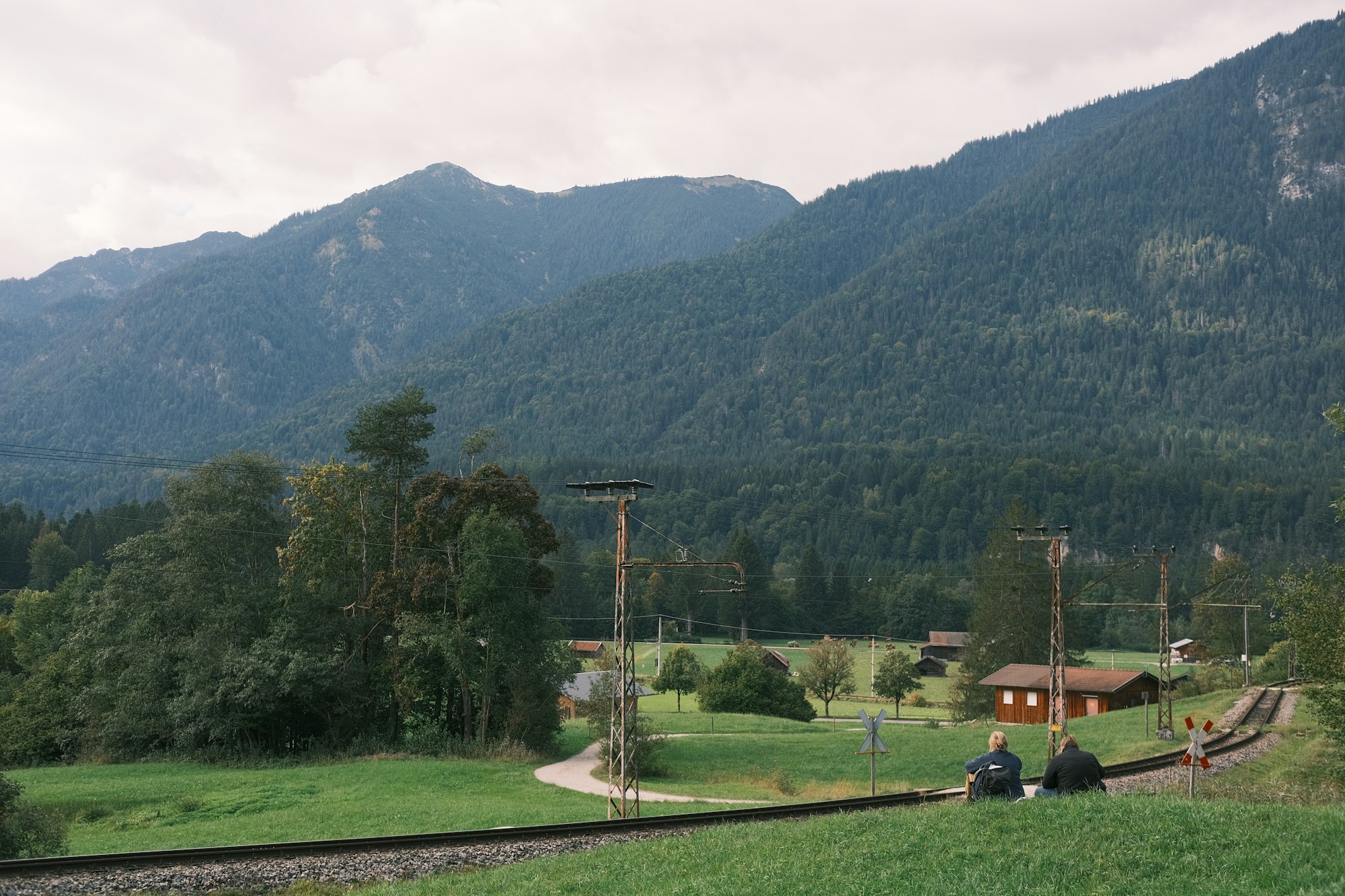 Train crossing lush green countryside in Europe, a symbol of slow travel