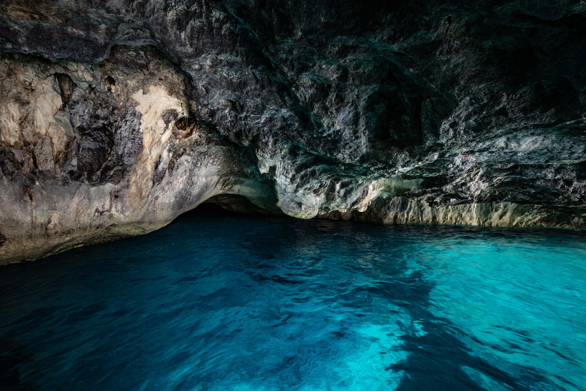 Crystal-clear blue water inside a natural tropical cave