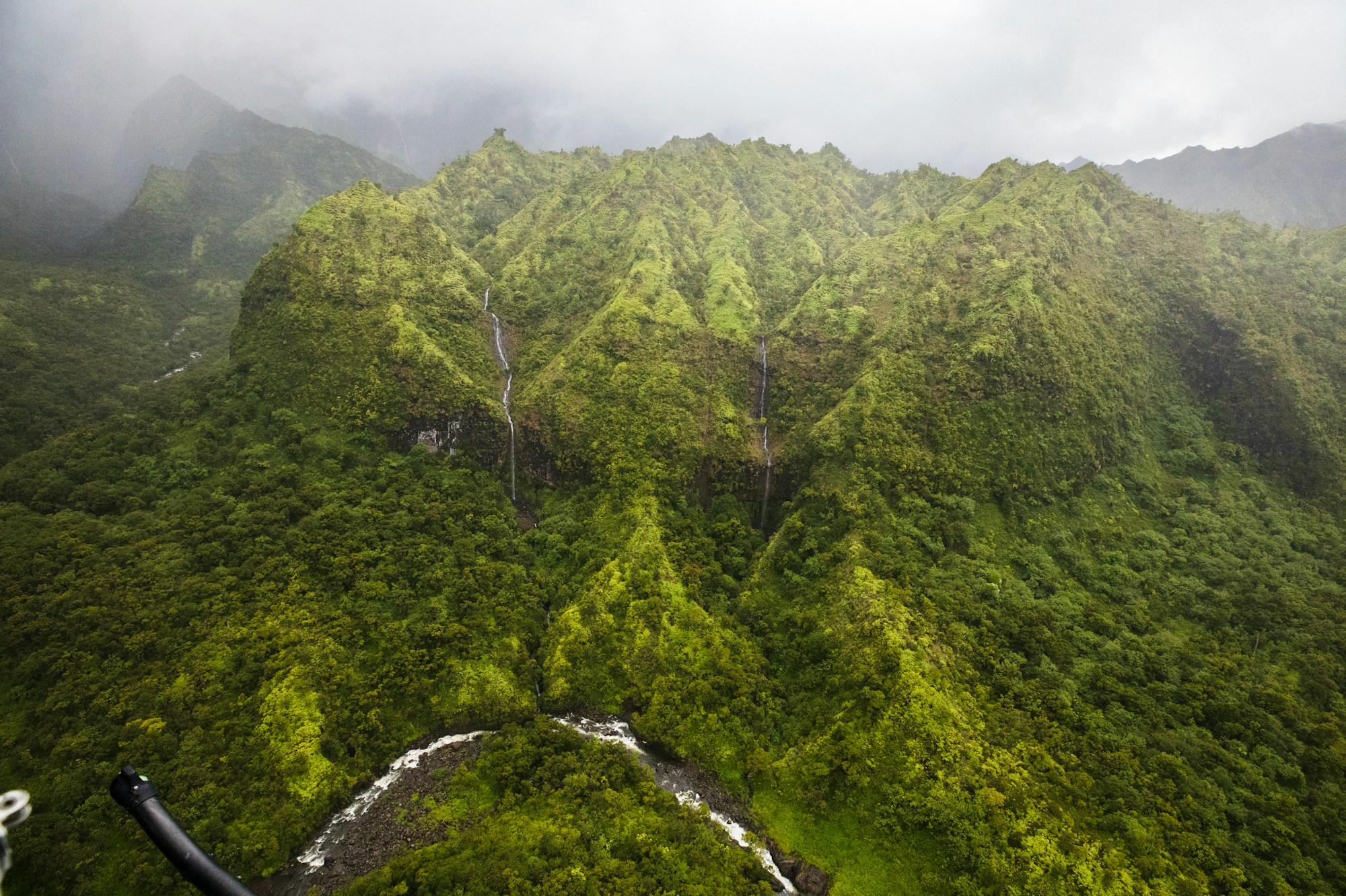 Aerial view of a lush green tropical mountain range