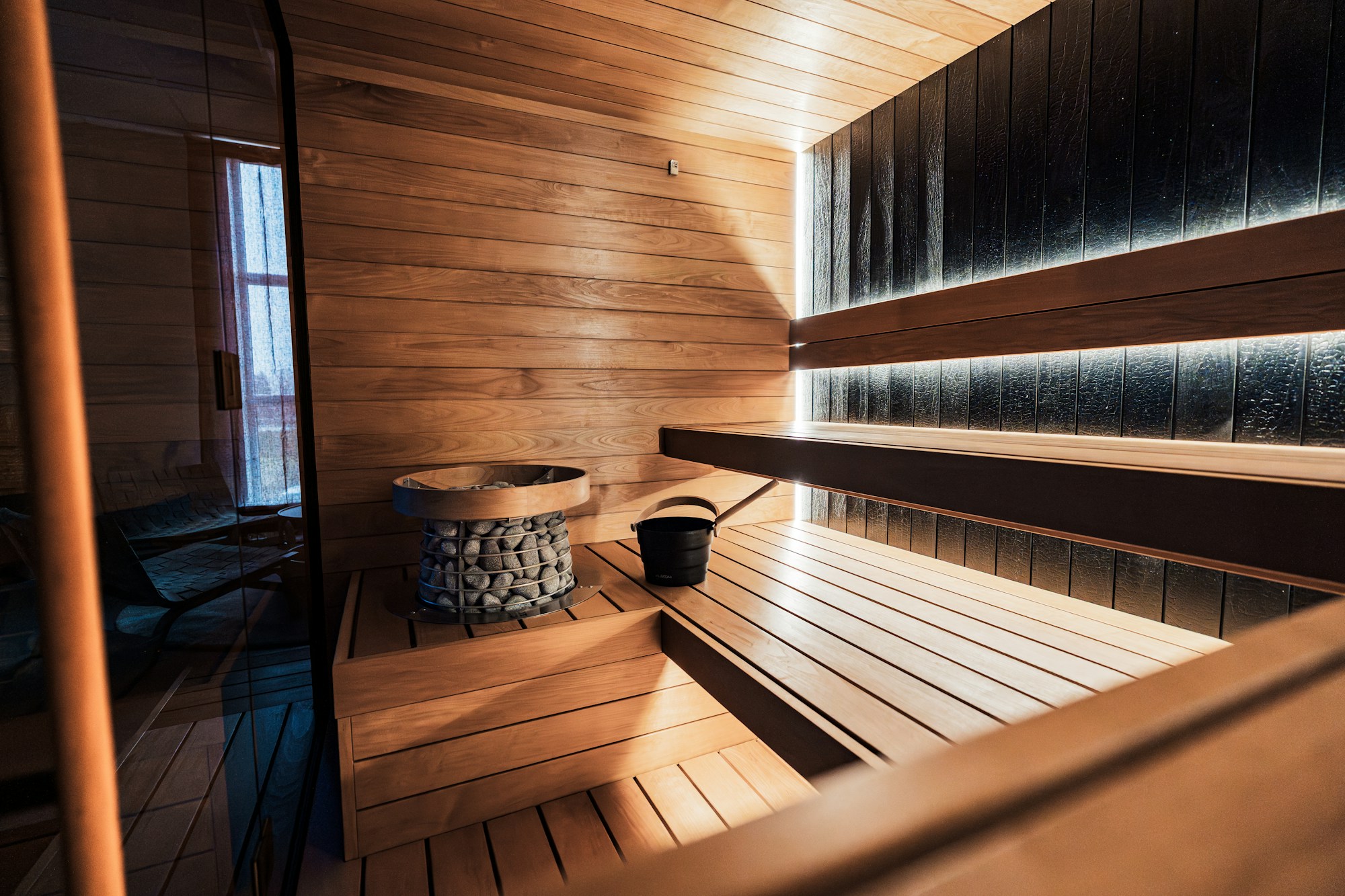 Warm interior of a contemporary Nordic sauna with wooden benches and soft lighting