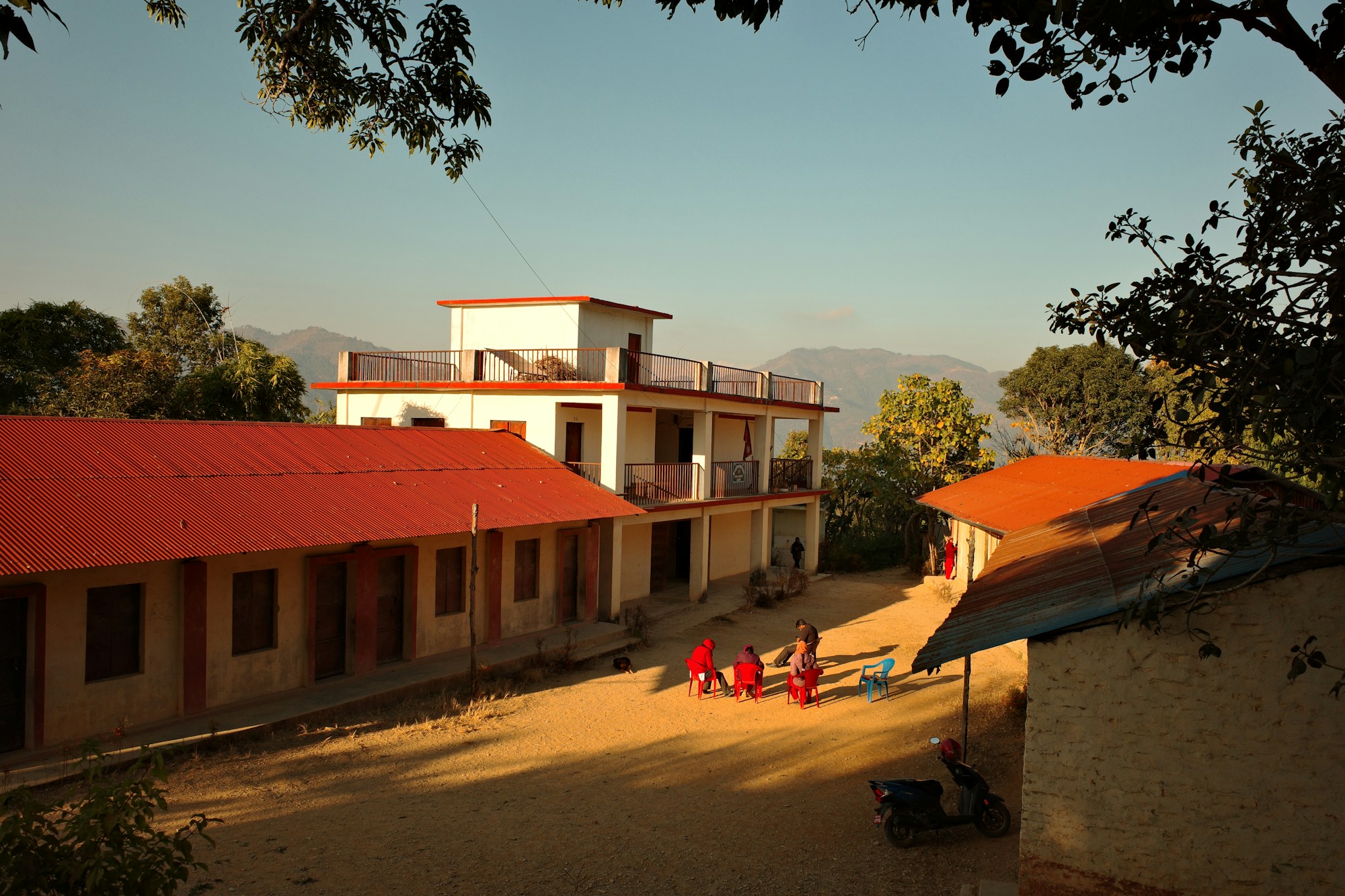 Children playing in a school courtyard in Nepal, illustrating the education and community development projects accessible to long-term volunteers