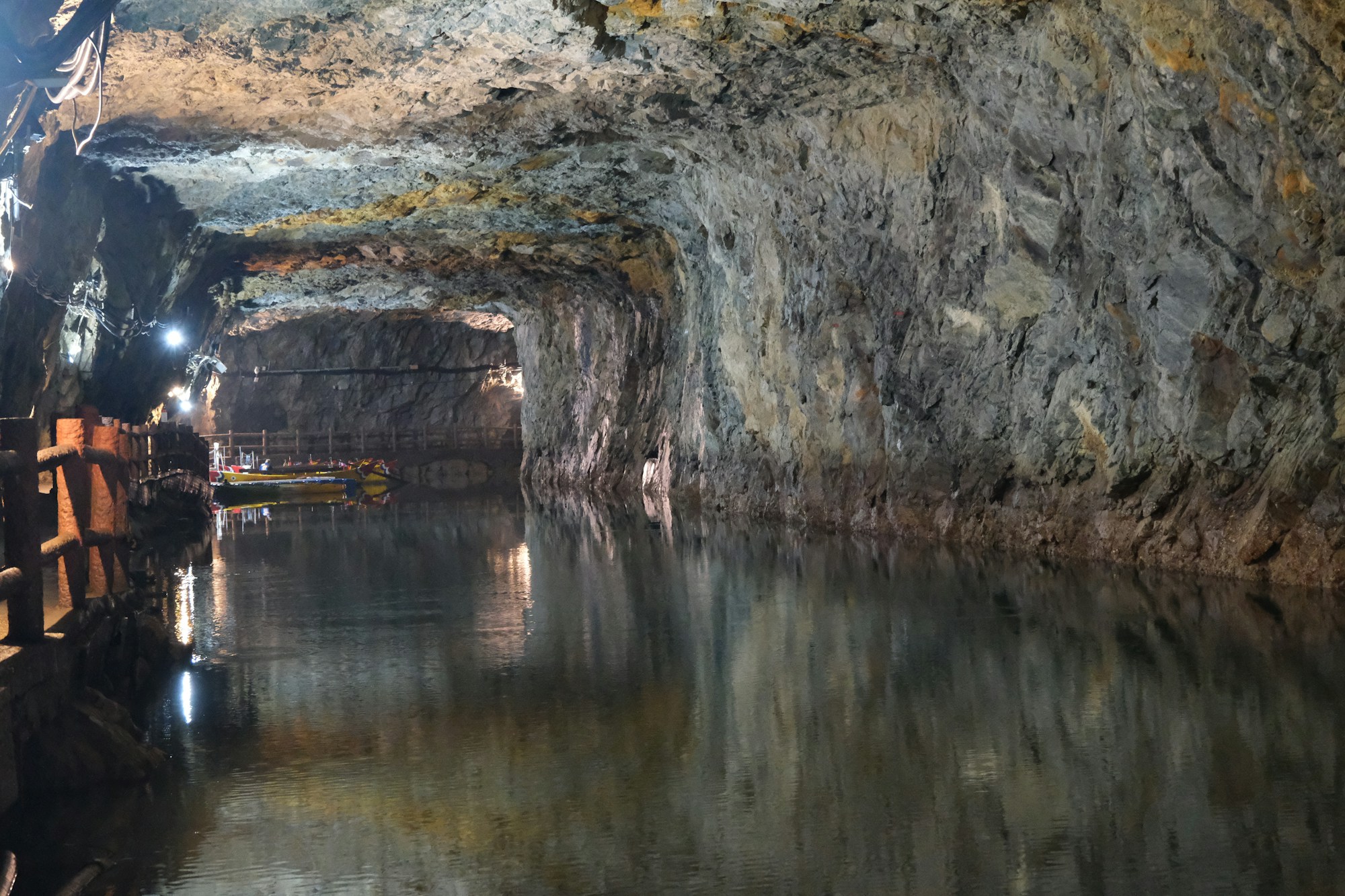 Illuminated underground cave with water and stalactites — unique cave exploration in Tenerife