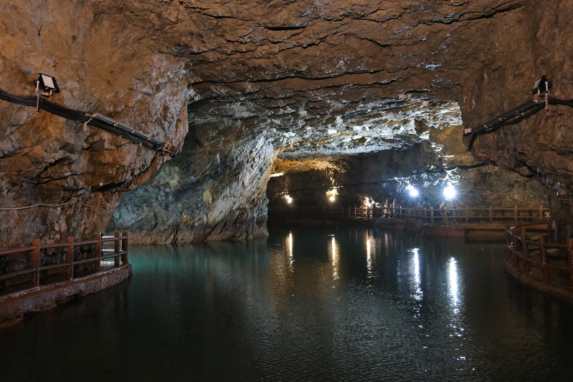 Underground cave with calm lake and light effects — speleological exploration in Europe