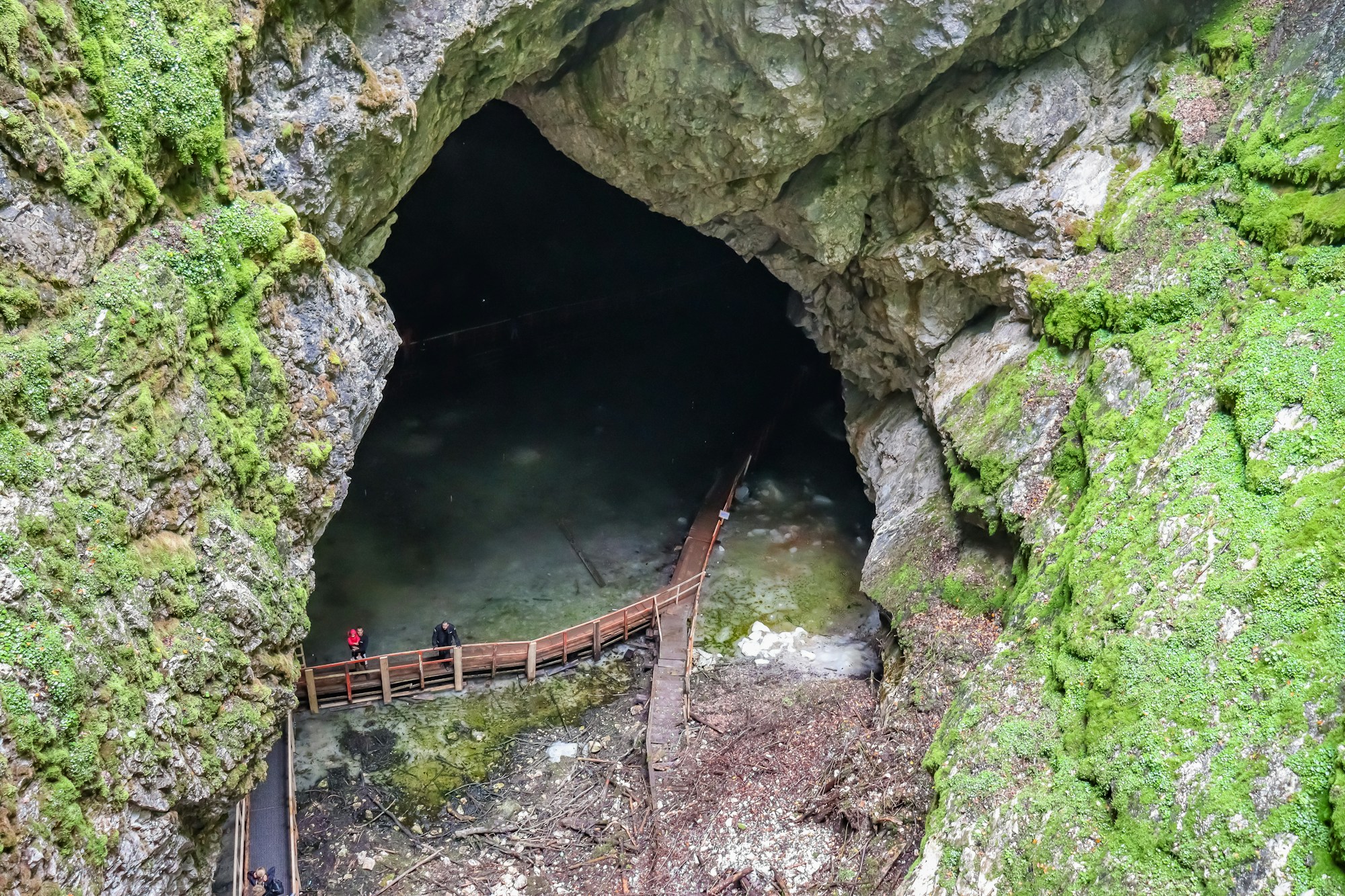 Entrance of a glacial cave in the mountains — high-altitude caving in Slovenia