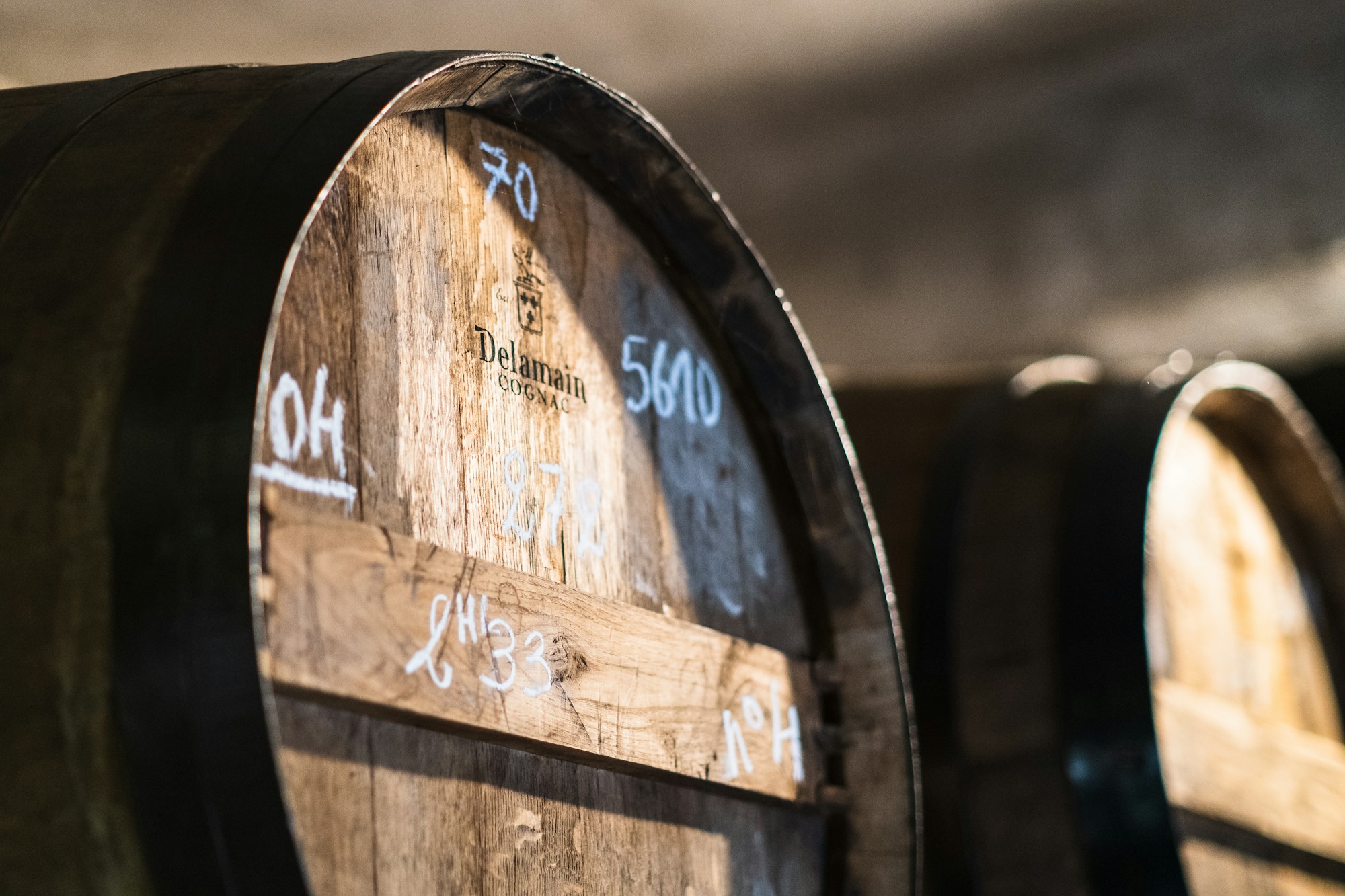 Close-up of a chalk-marked cognac barrel in a Delamain cellar, Jarnac, Charente, France