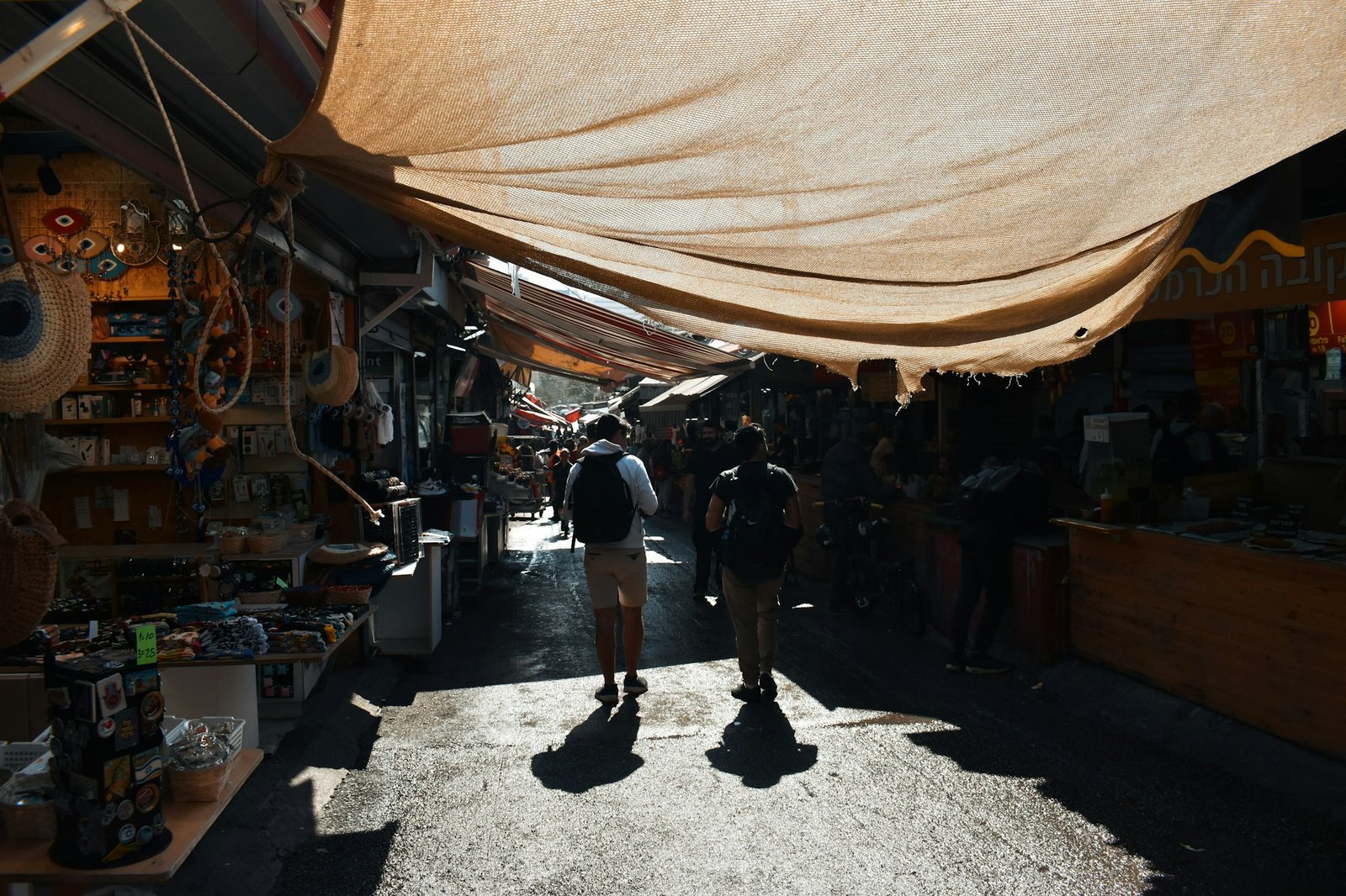 Bustling market in Tel Aviv, Israel, with sun-drenched aisles and fresh produce stalls