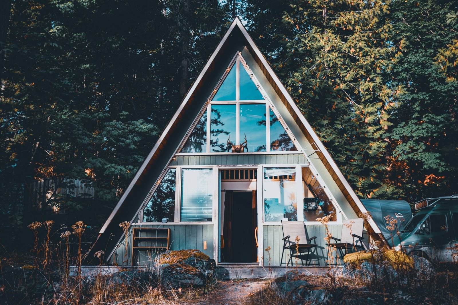 Triangular A-frame wooden cabin in a snowy mountain landscape, North America