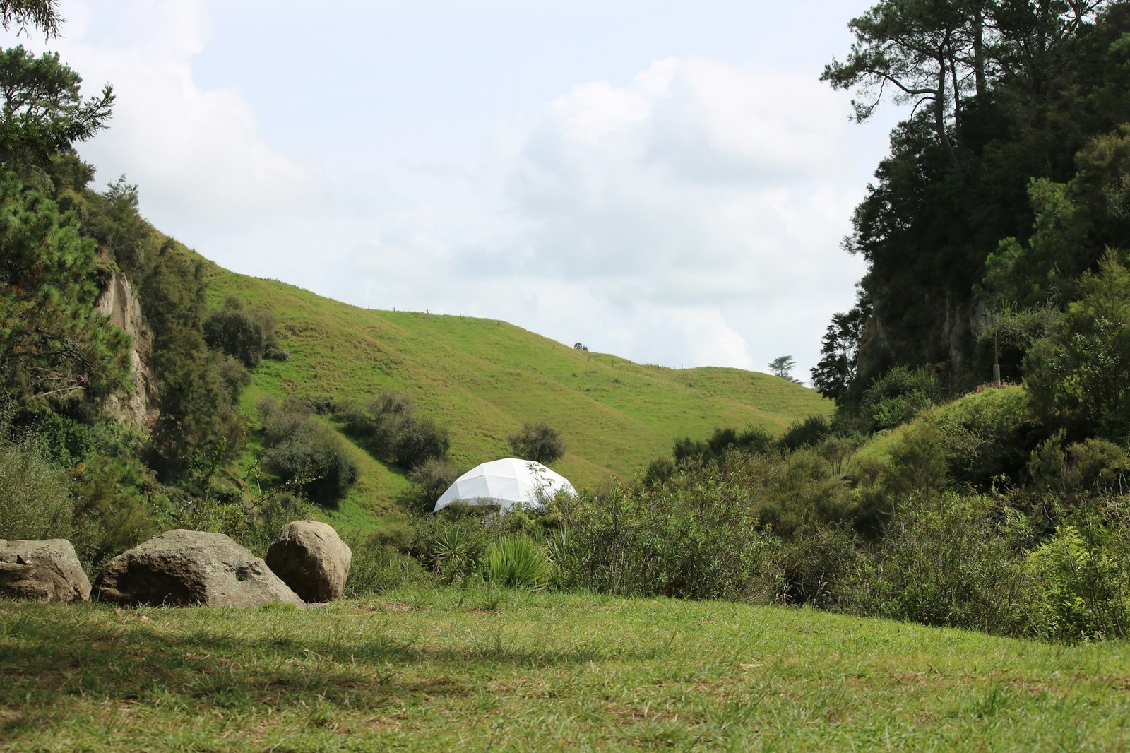 Transparent geodesic dome in a natural setting, luxury glamping alternative accommodation
