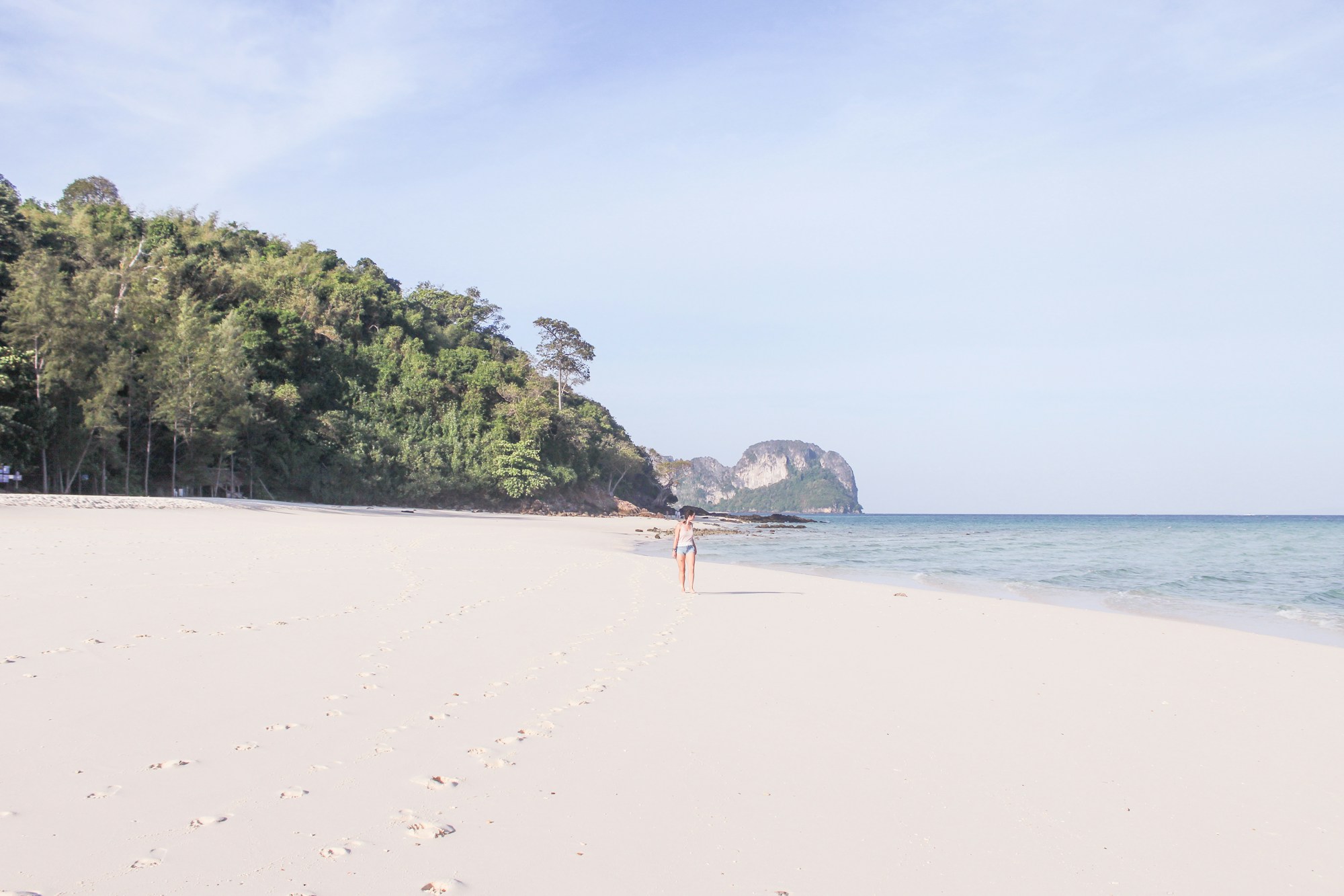 Sandy beach and turquoise waters in Phuket, setting for luxury wellness retreats in Thailand